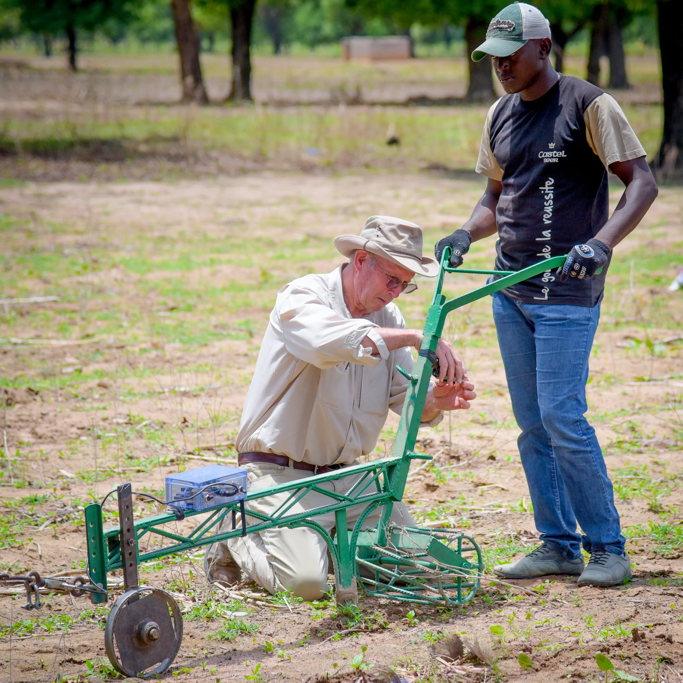 A partnering professor from Michigan State University with a graduate student from Polytechnic University of Bobo-Dioulasso field testing a rippling plow in the West African country of Burkina Faso.