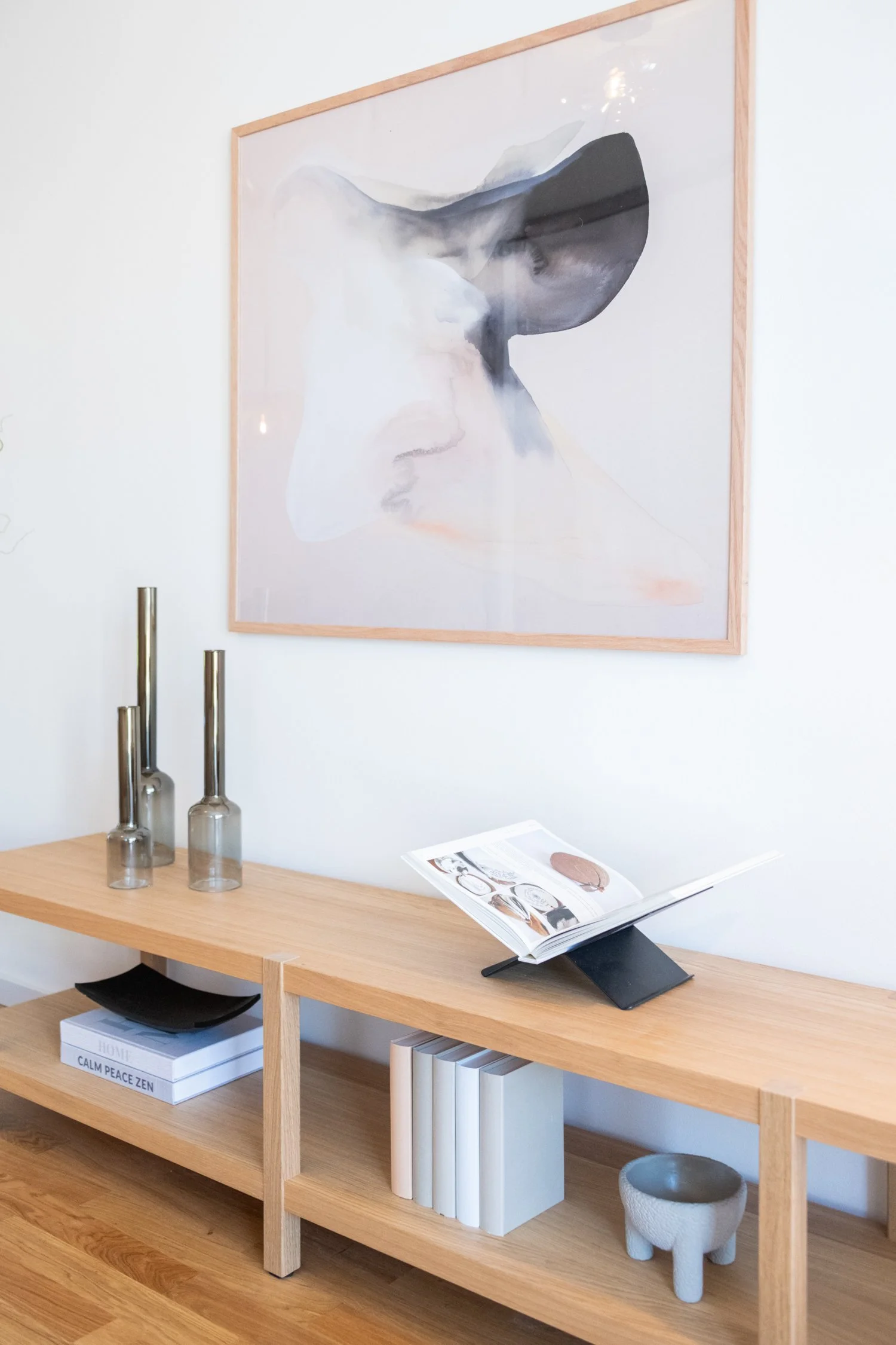 Fragment of a modern living space combining stylish seating, décor, and wall art