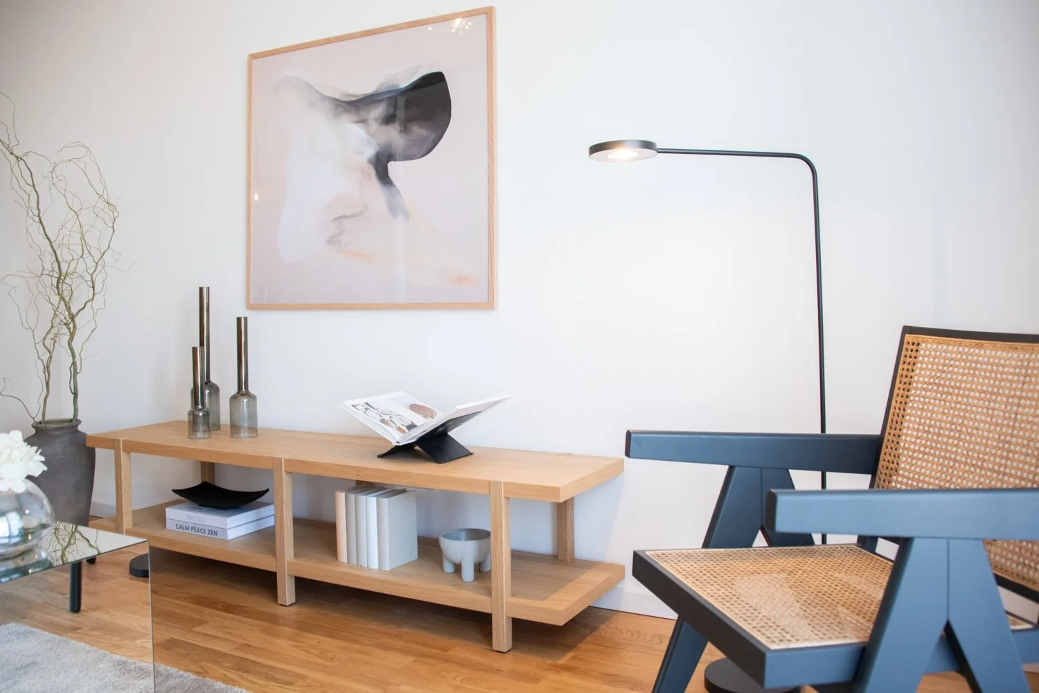 Fragment of a modern living space combining stylish seating, décor, and wall art