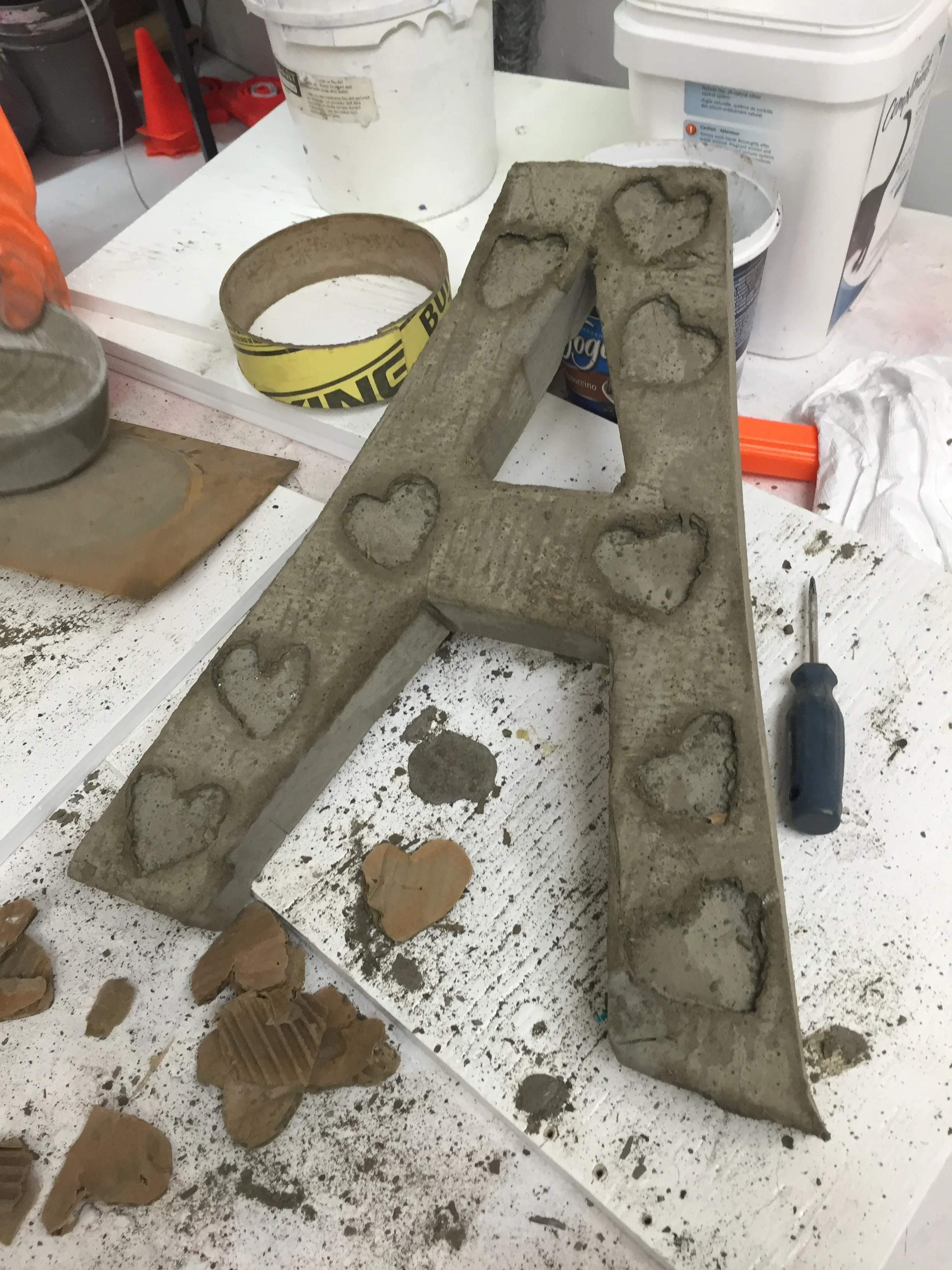 A big concrete 'A' fresh from a mold.
