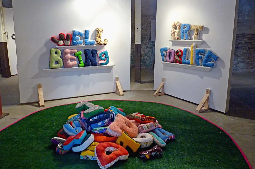 TEXT-ing et al was exhibited at the Mississippi Valley Textile Museum (Almonte, Ontario) from October 21, 2010-January 24, 2011. The exhibition featured a public intervention with over 50 pillows letters in which the public was invited to create words, take pictures and rest or lounge with their favorite letter. Images were uploaded to a flickr site created for the project. A web cam broadcast this intervention during the museum’s public hours and was featured on Museum’s website during the run of the exhibition. Additional interactive word-making opportunities included magnetic letters, velcro letters and a chalk board. In addition to the Latin alphabet, soft sculptures were created in other languages including Mandarin, Hindi and Russian, as an exploration of scripts in Chinese Characters, Devanagari and Cyrillic, the most spoken languages in the world that use a script other than the Latin alphabet.