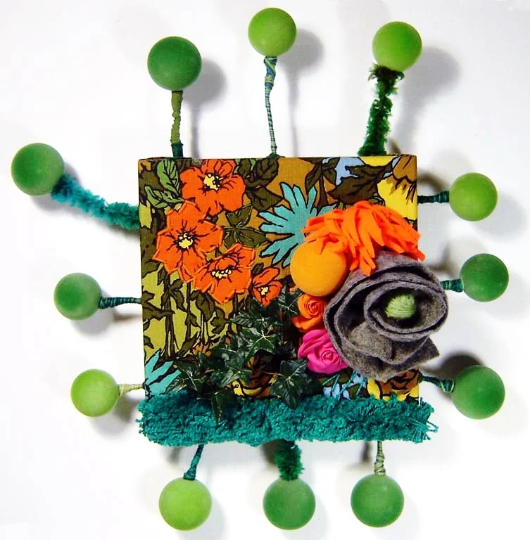 Cozy: New Fibre Work Solo Exhibition at Ottawa's Atrium Gallery in October 2007 at Ottawa's Atrium Gallery. With these new sculptures and wall pieces, I explored surface as a means for detail, layers, hidden treasures, and as always, playing with colour. Much of my materials are reclaimed and recycled fabric, thread, string and wire. By using other people’s cast-offs and unwanted detritus, I am putting beauty back into the world that would have otherwise added to the land fill. I continue to use organic forms and revel in hippy, drippy plants, vegetation, trees, along with cheerful shapes that surprise and delight. I thrive on challenging myself to invent new methods of creating objects and organizing disorder into structured, bite-sized pieces of art. image above: Flower Garden