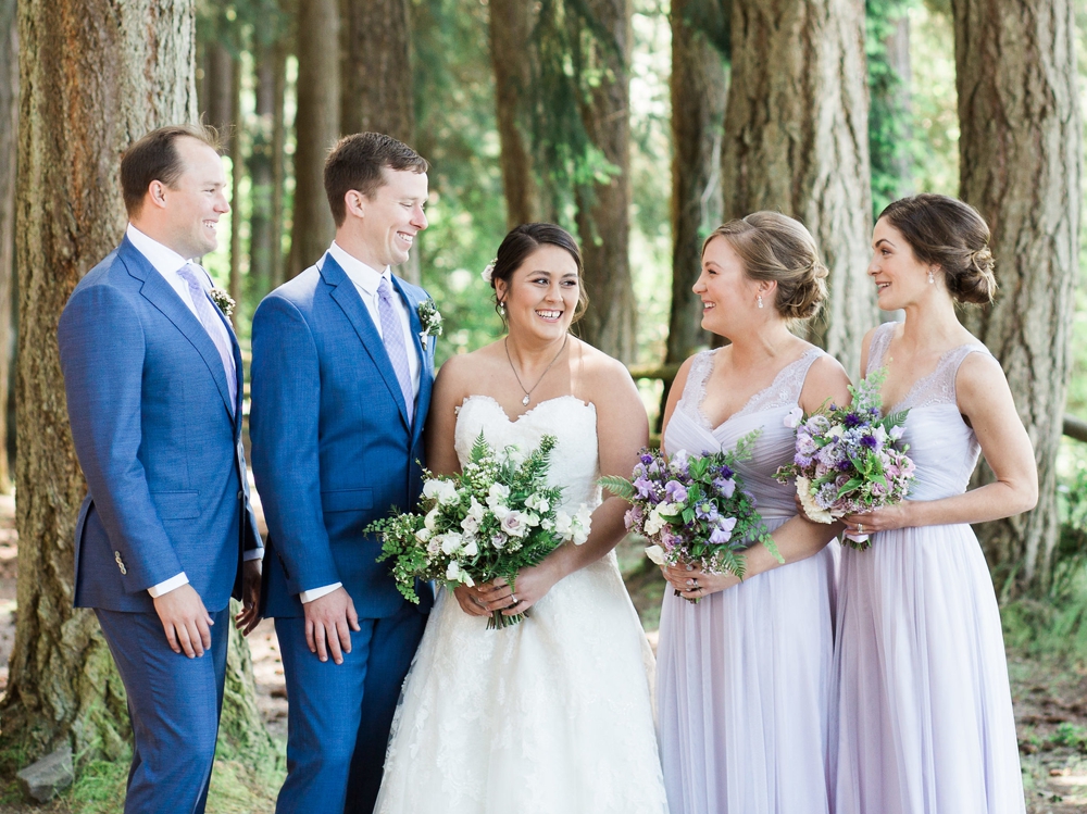  bridal party holding white and lavender spring bouquets   