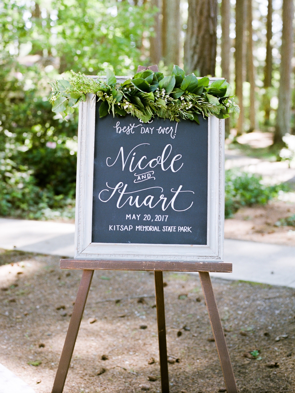  wedding welcome chalkboard with green foliage 