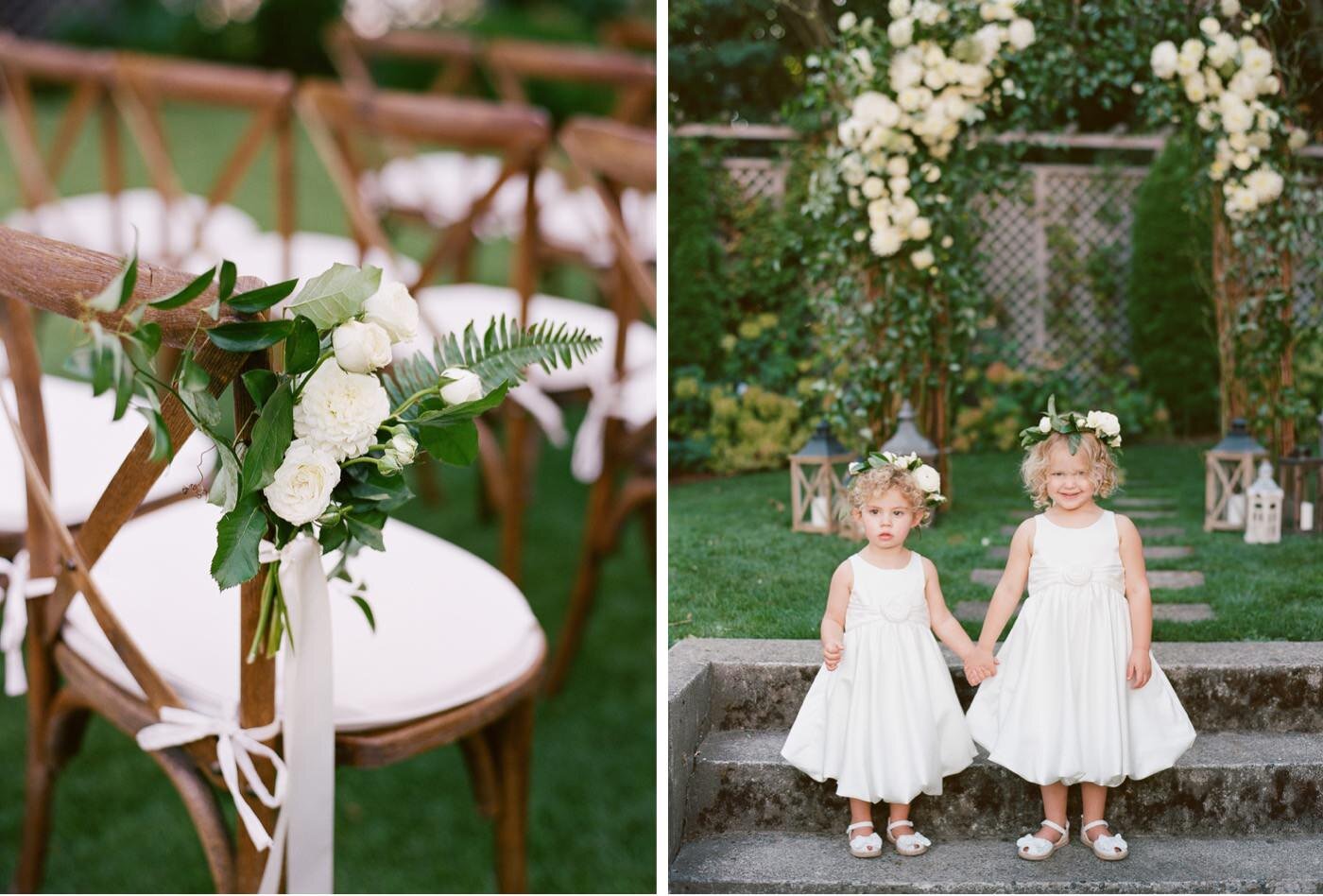 Flowergirls with flower crowns pose in front of a lush white and green ceremony arch