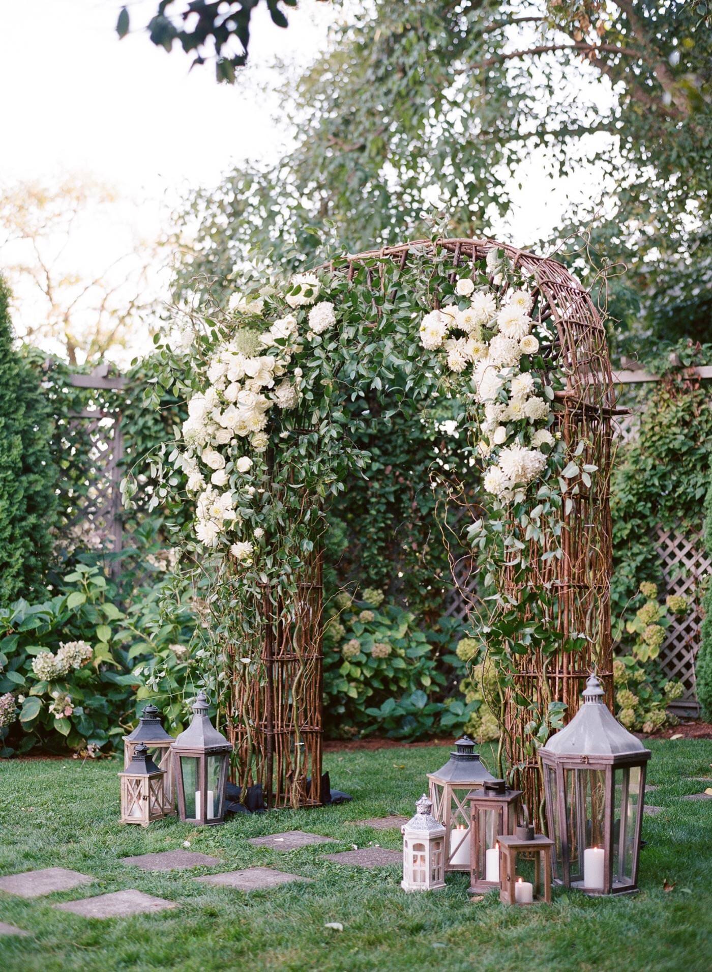 A classic and lush white and green ceremony arch from Seattle Wedding Florist Gather Design Company