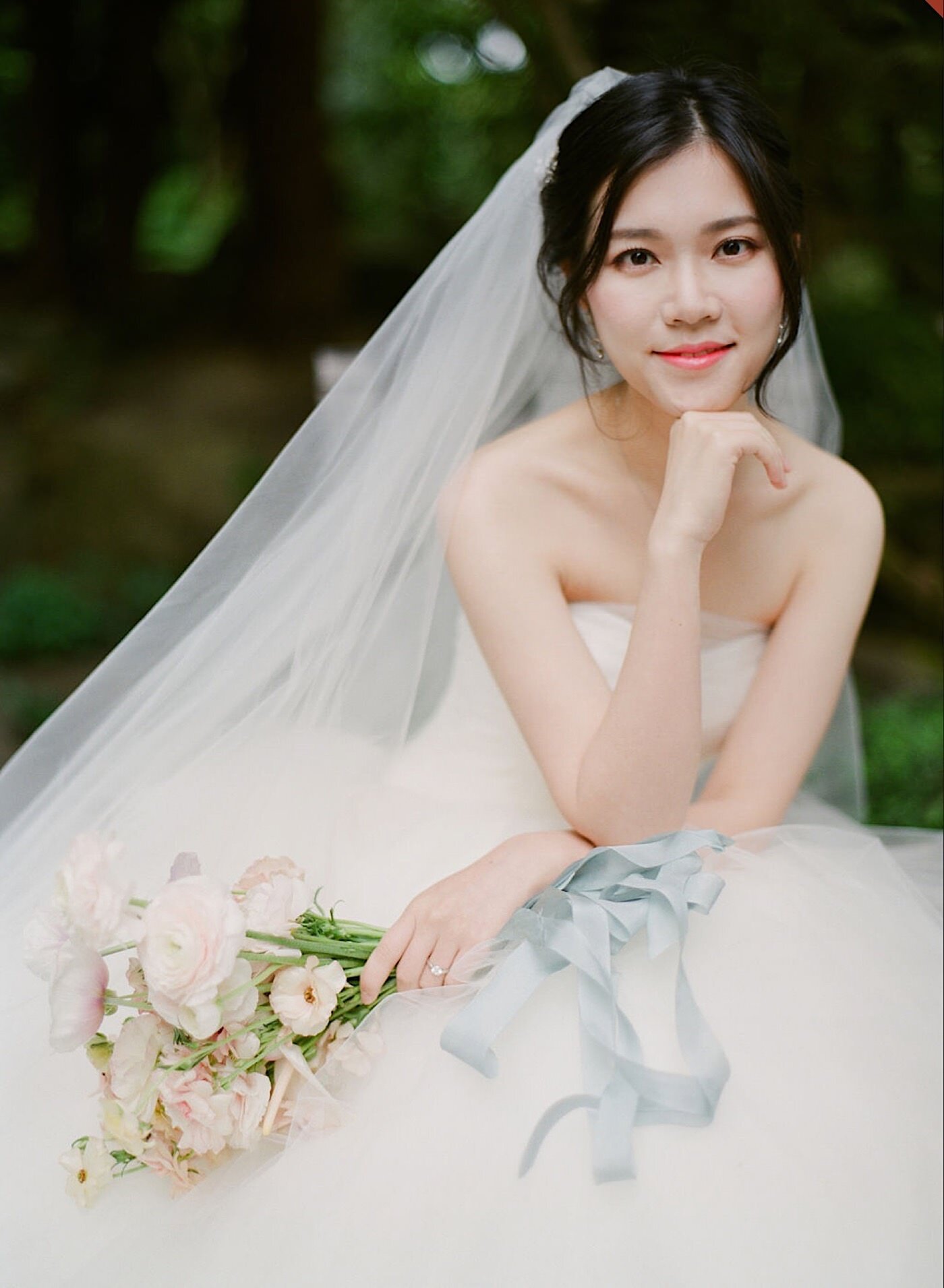 Bride poses with a pastel bouquet from Seattle Wedding Florist Gather Design Company