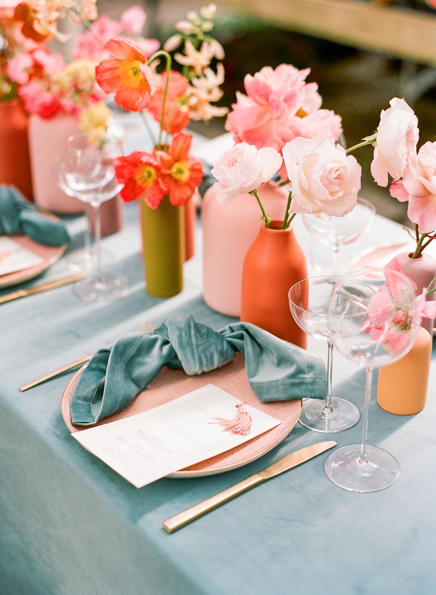 Colorful wedding tablescape at Christianson's Nursery with teal linen