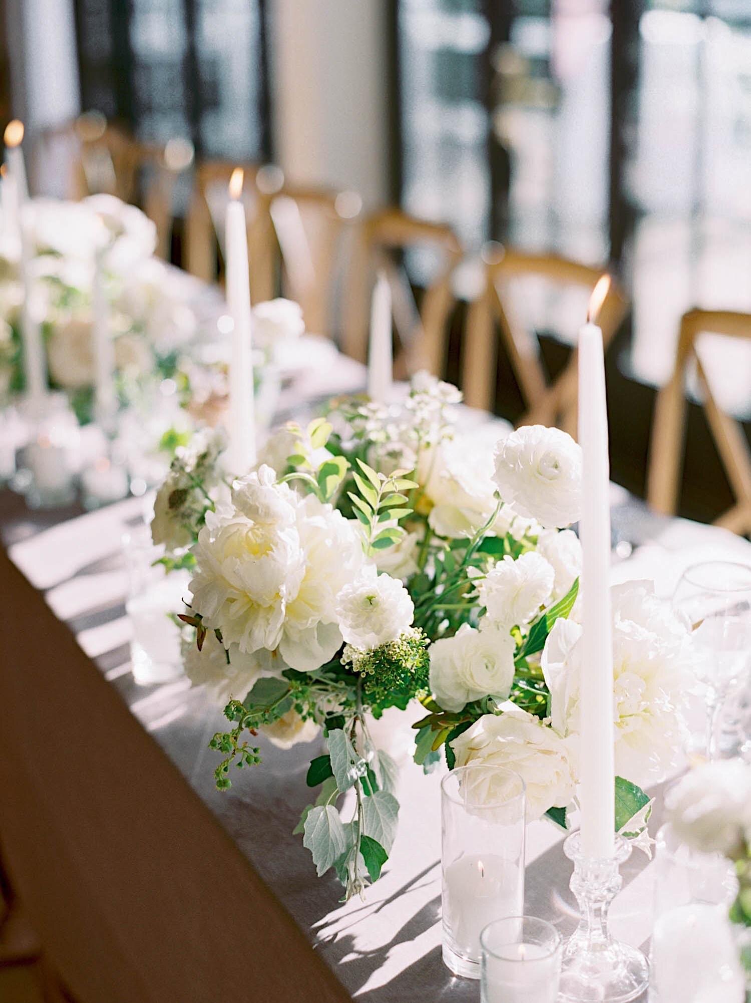 White and green centerpieces with white tapers at a Roche Harbor wedding reception