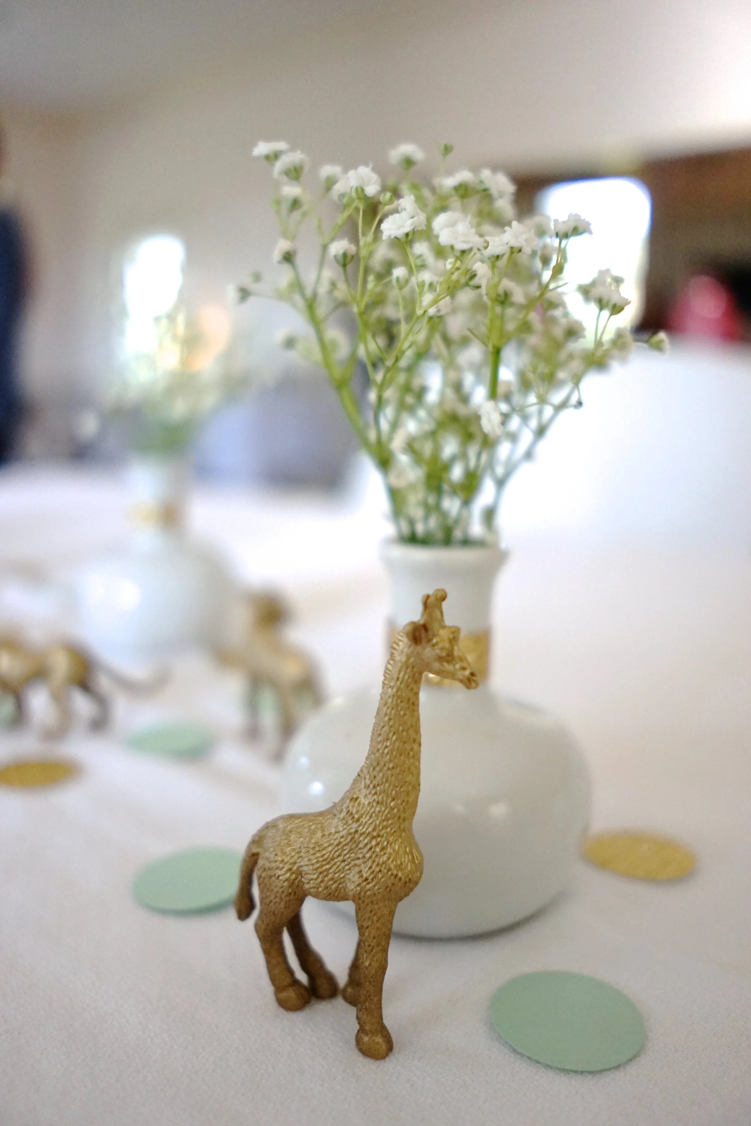 Mint + Gold Safari Baby Shower Brunch This simple and elegant baby shower brunch for mom-to-be Katherine features gold-painted safari animals and a sophisticated color palette of mint, gold and white. Be sure to check out the children's book gift station and the boxed animal cracker favors.