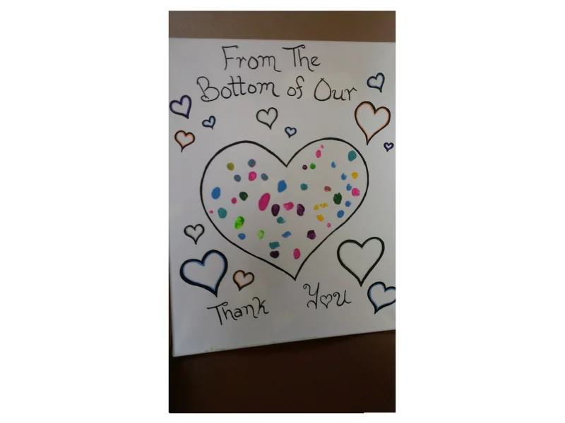 Frame of Children's Fingerprints and Hearts presented to Hazel at her CAPC retirement party