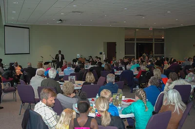 Melvin Payekar introducing the speaker, Agnes Cole. .