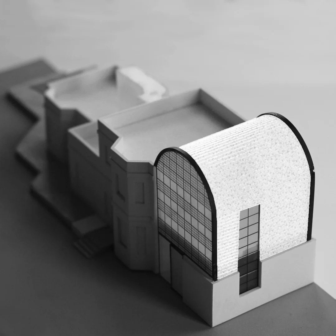 Cemetery lodge extension featuring glazed terracotta tiles to a curved roof