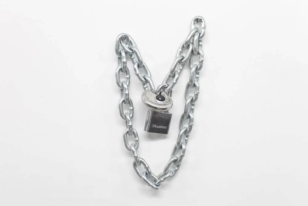 i’ve had kisses that make judas seem sincere…,&nbsp;2013, Chain and padlocks,&nbsp;16 x 16 x 4 inches
