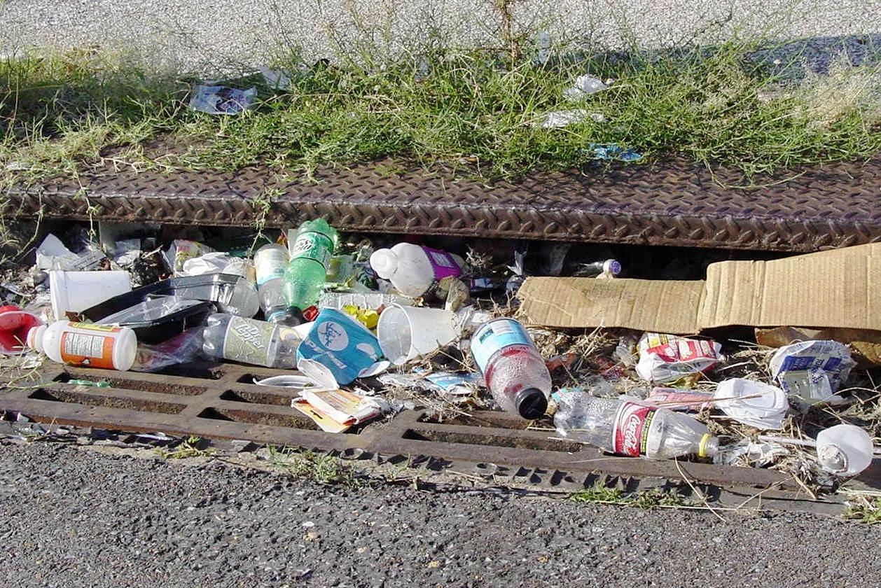 Storm drain inlet with beverage containers and litter.jpg