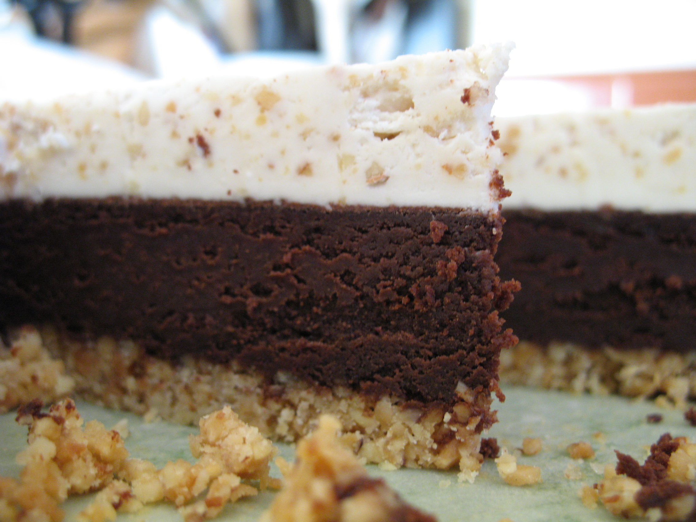 Almond Nut Crust with an Almond Scented Truffle Brownie Layer topped with Almond Icing