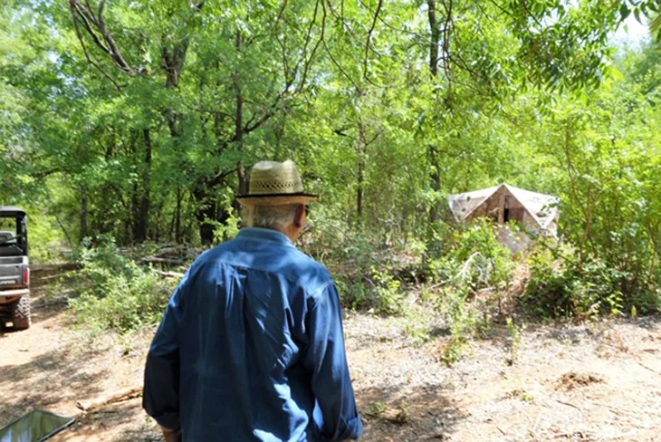 Sri M taking a closer look at a tent