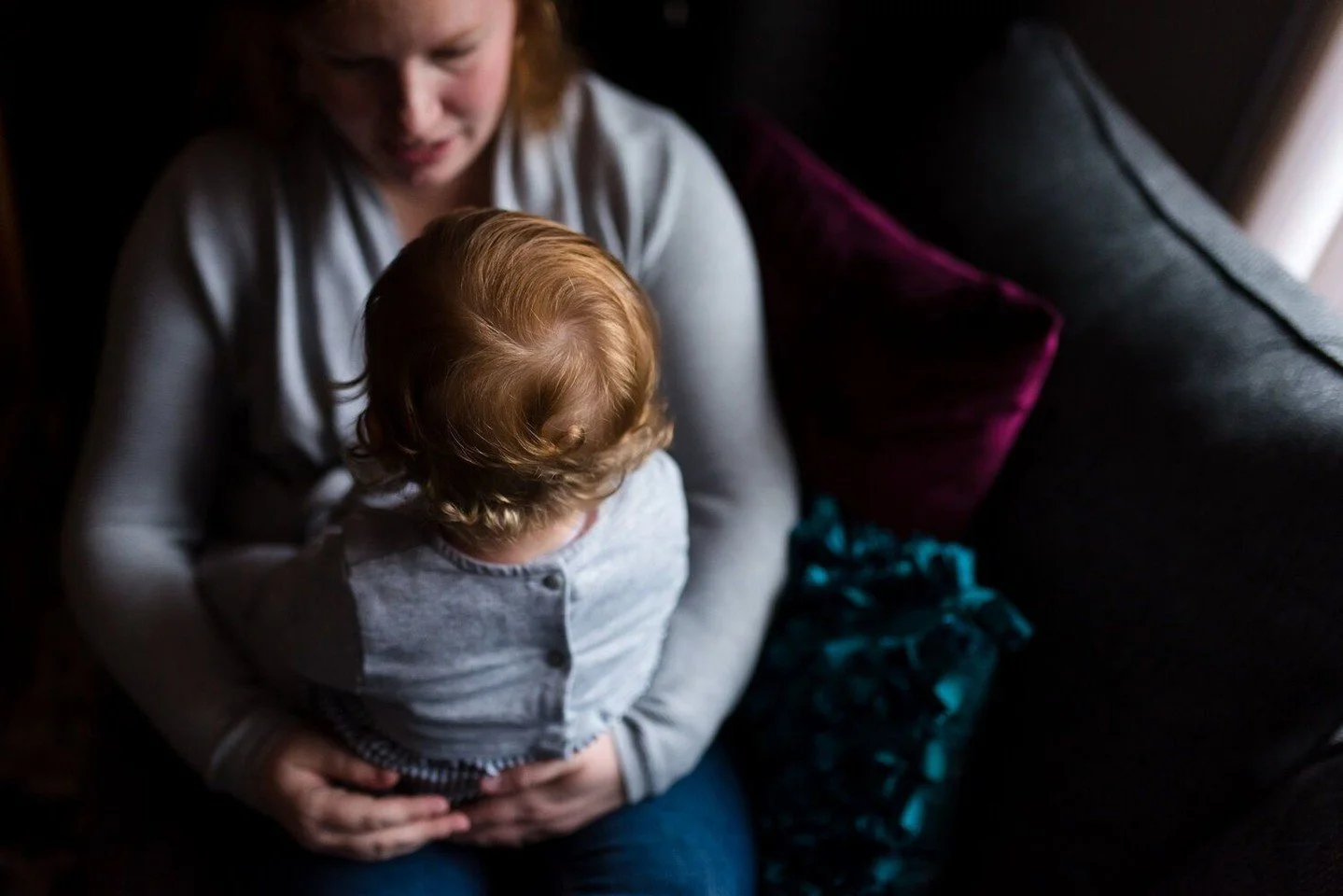 The little baby, the start of a curl on the back of her head, the soft hold, the face to face interaction and connection. Those are all reasons you should schedule a family photo session. I use a lifestyle and child-led approach and I'm going after t