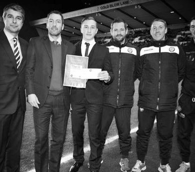 With colleagues presenting a Football League Award on match day
