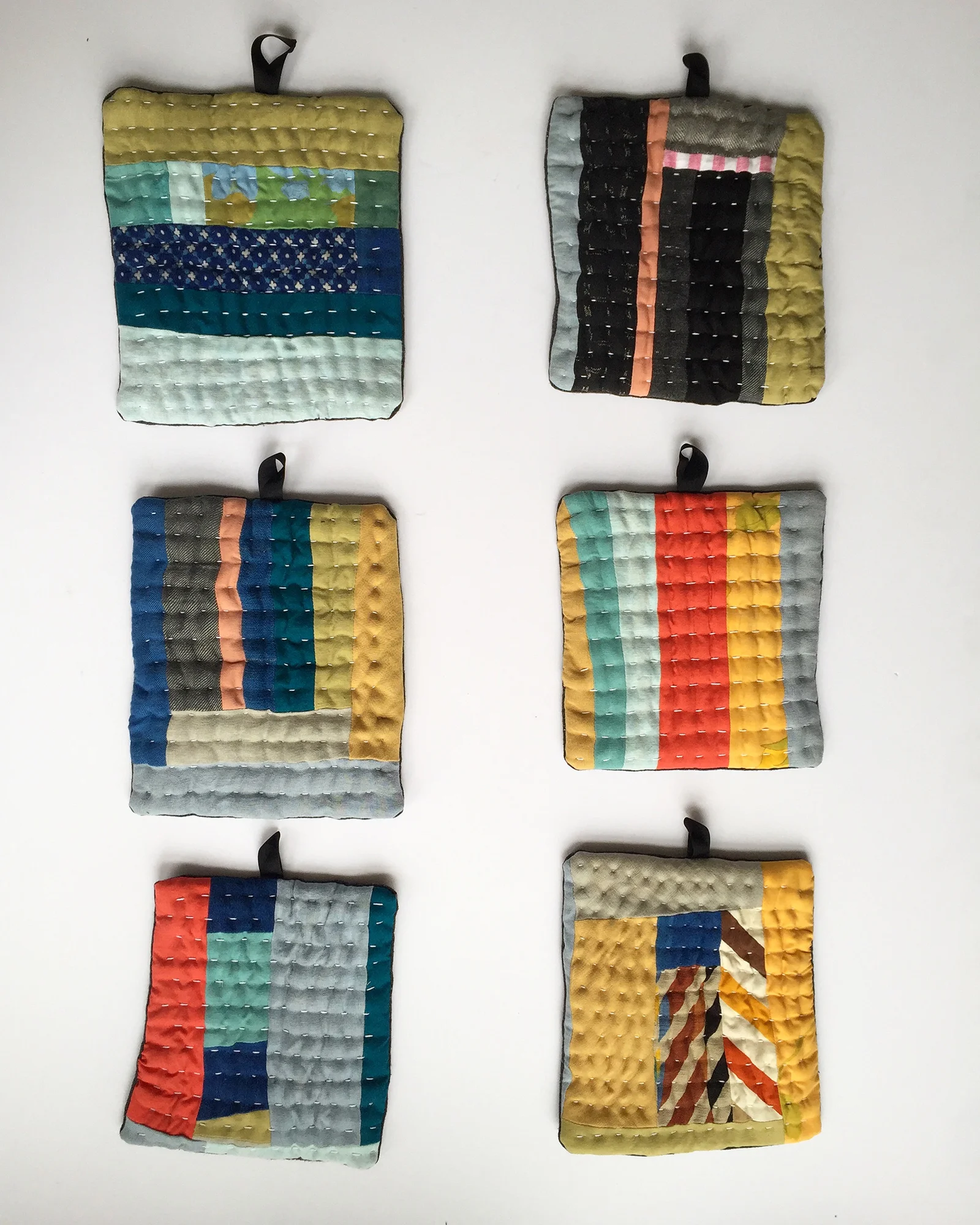 Pieces Pot Holders // Machine pieced from fabric scraps, mostly linen, all repurposed. Lined with boiled wool and hand stitched. // February 2018