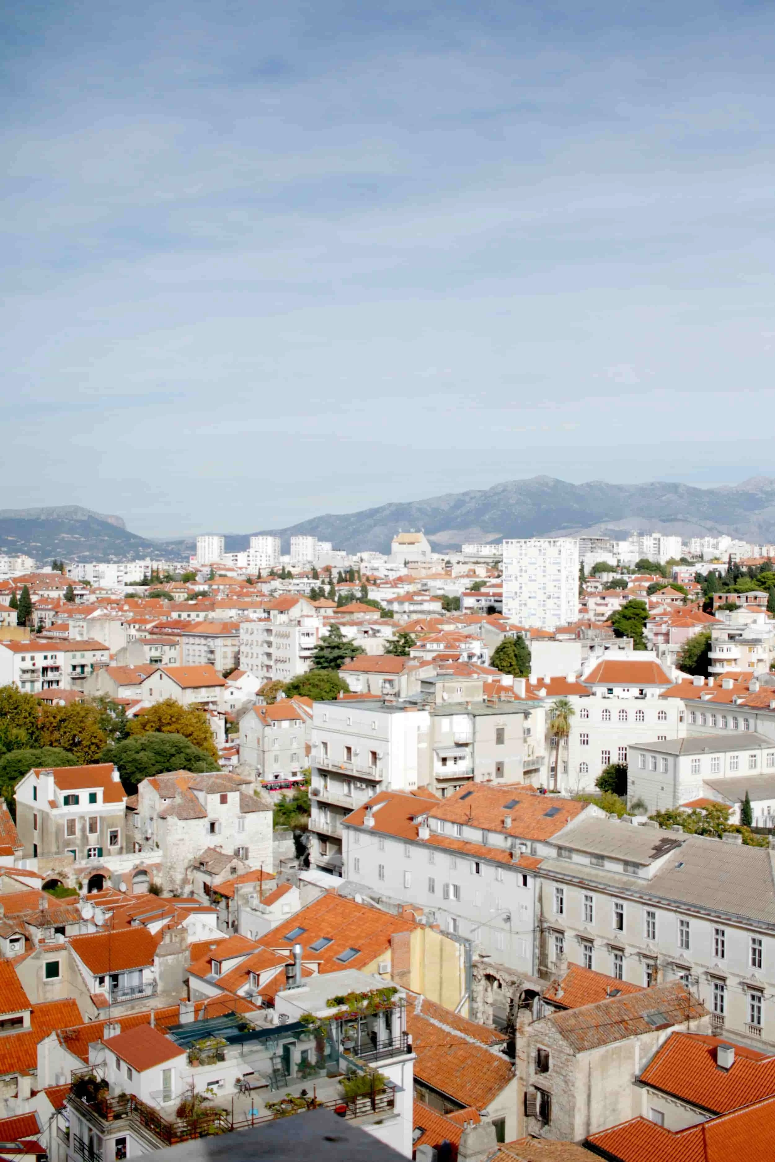 Views of Split from above, terra cotta rooftops and mountains beyond