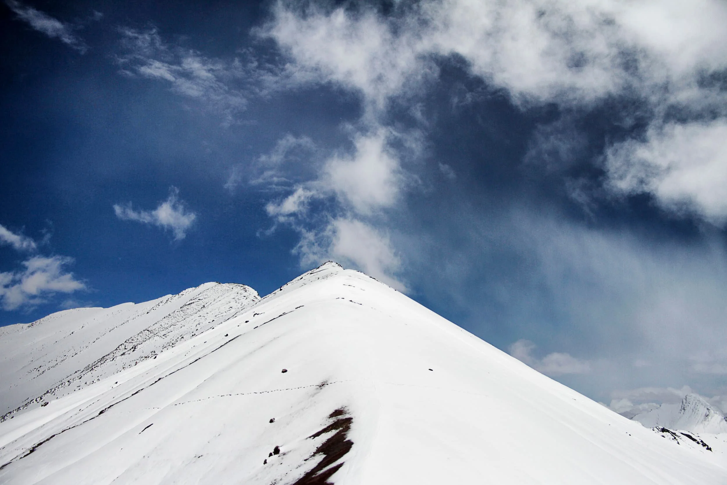 View of snowy mountaintop, Rainbow Mountain covered in snow, in Peru