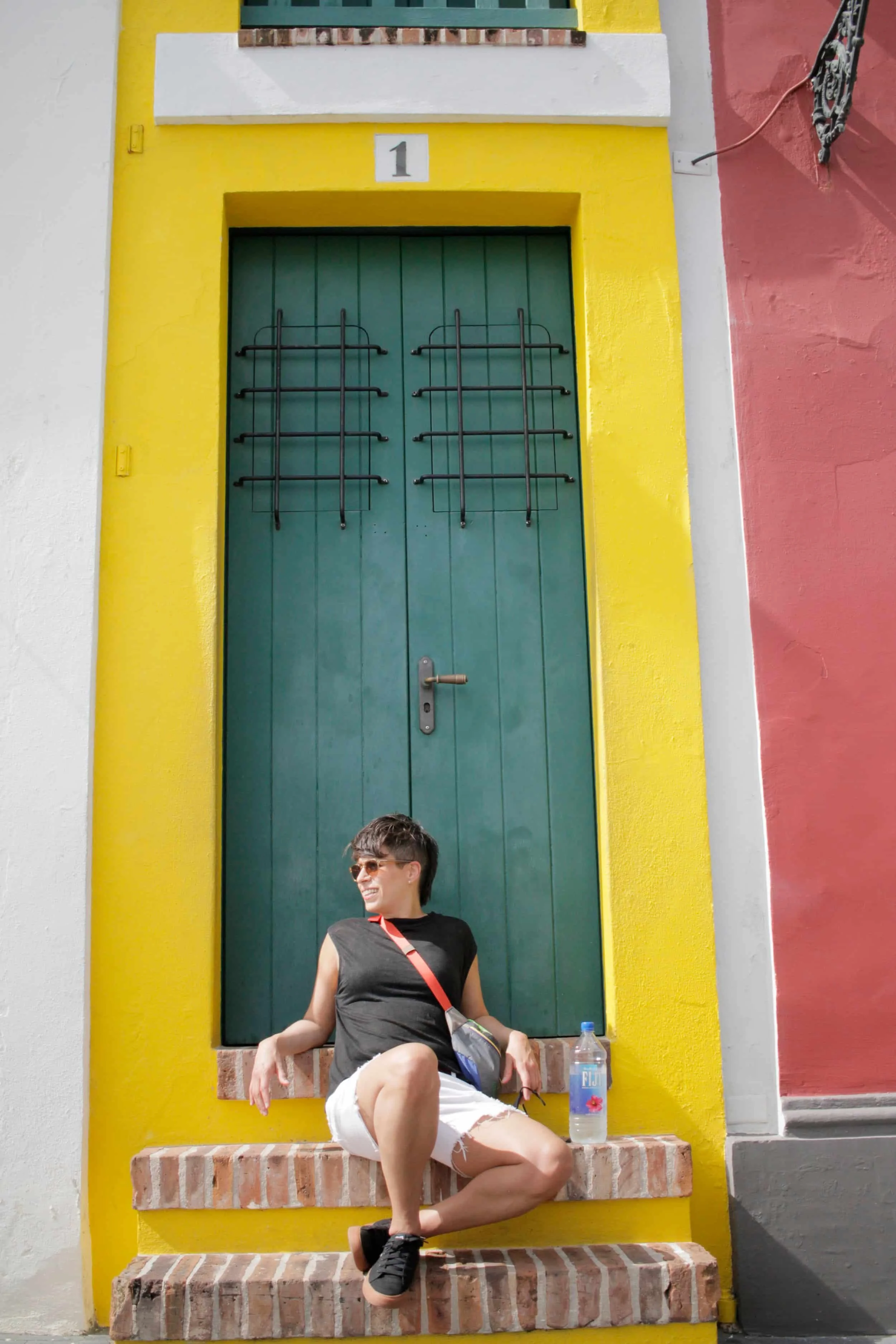 Narrow House in Viejo San Juan PR, brick steps, yellow accent paint and green front door