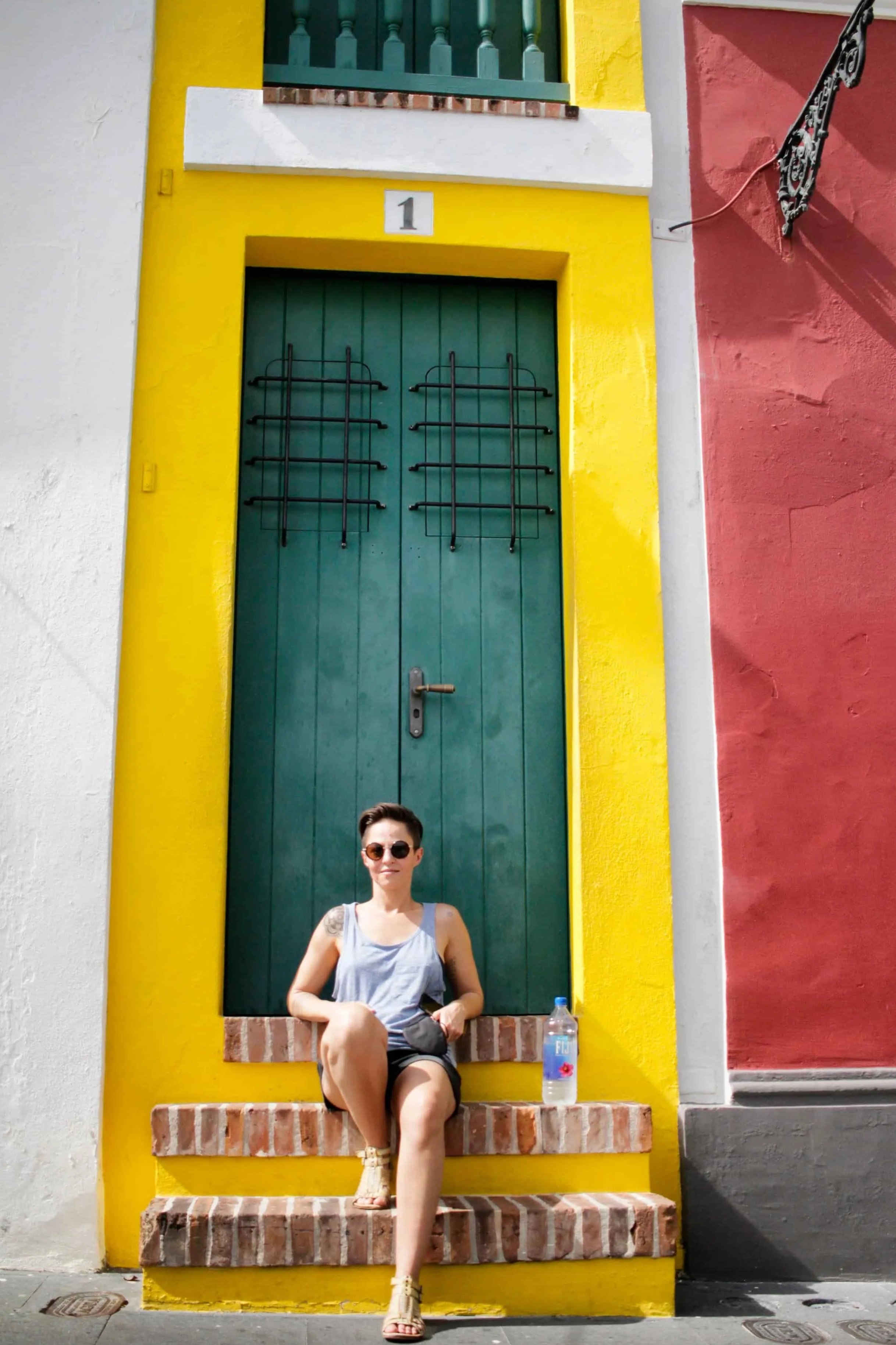Narrow House in Viejo San Juan PR, brick steps, yellow accent paint and green front door