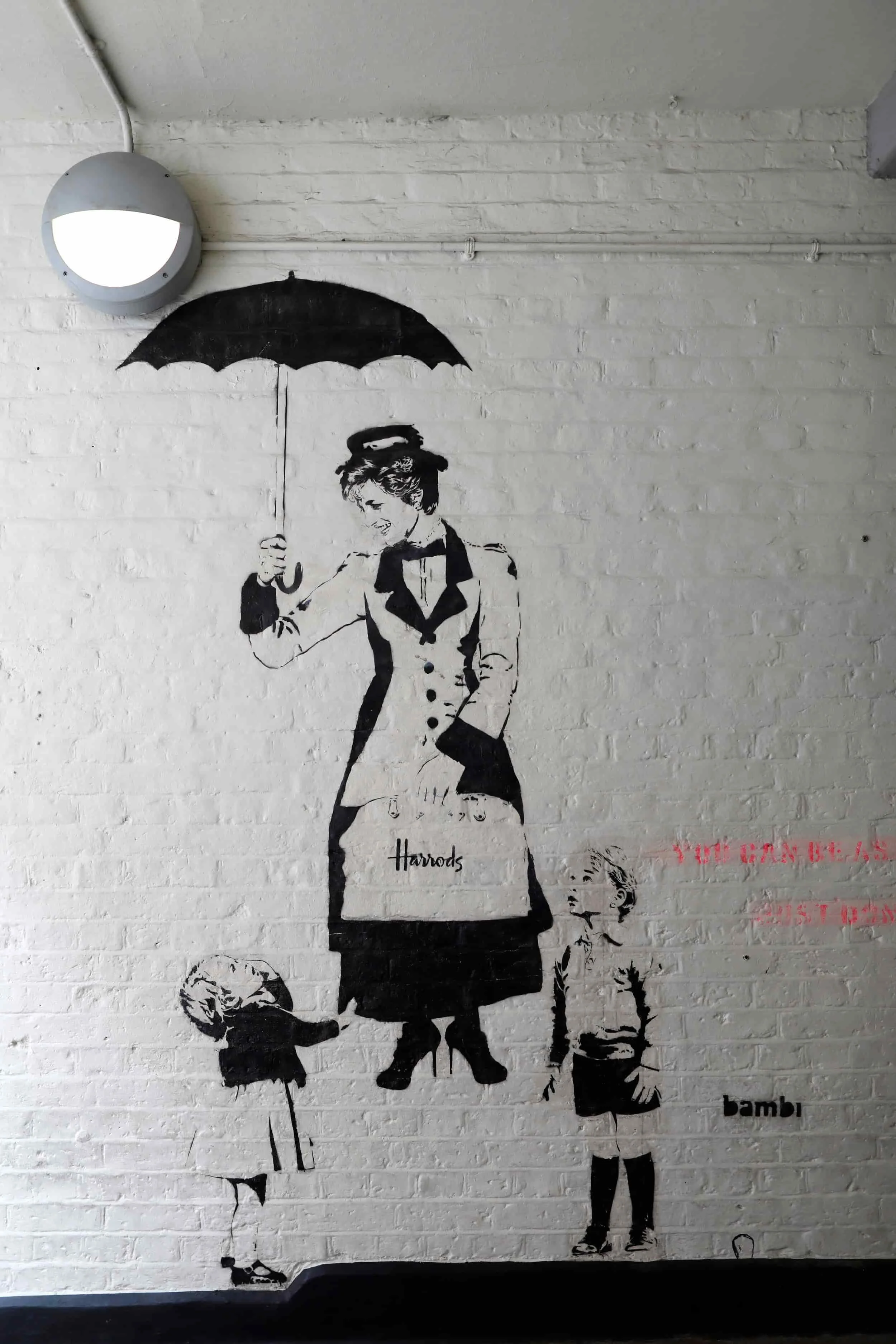 Black and white graffiti art on a brick wall of Princess Diana in London
