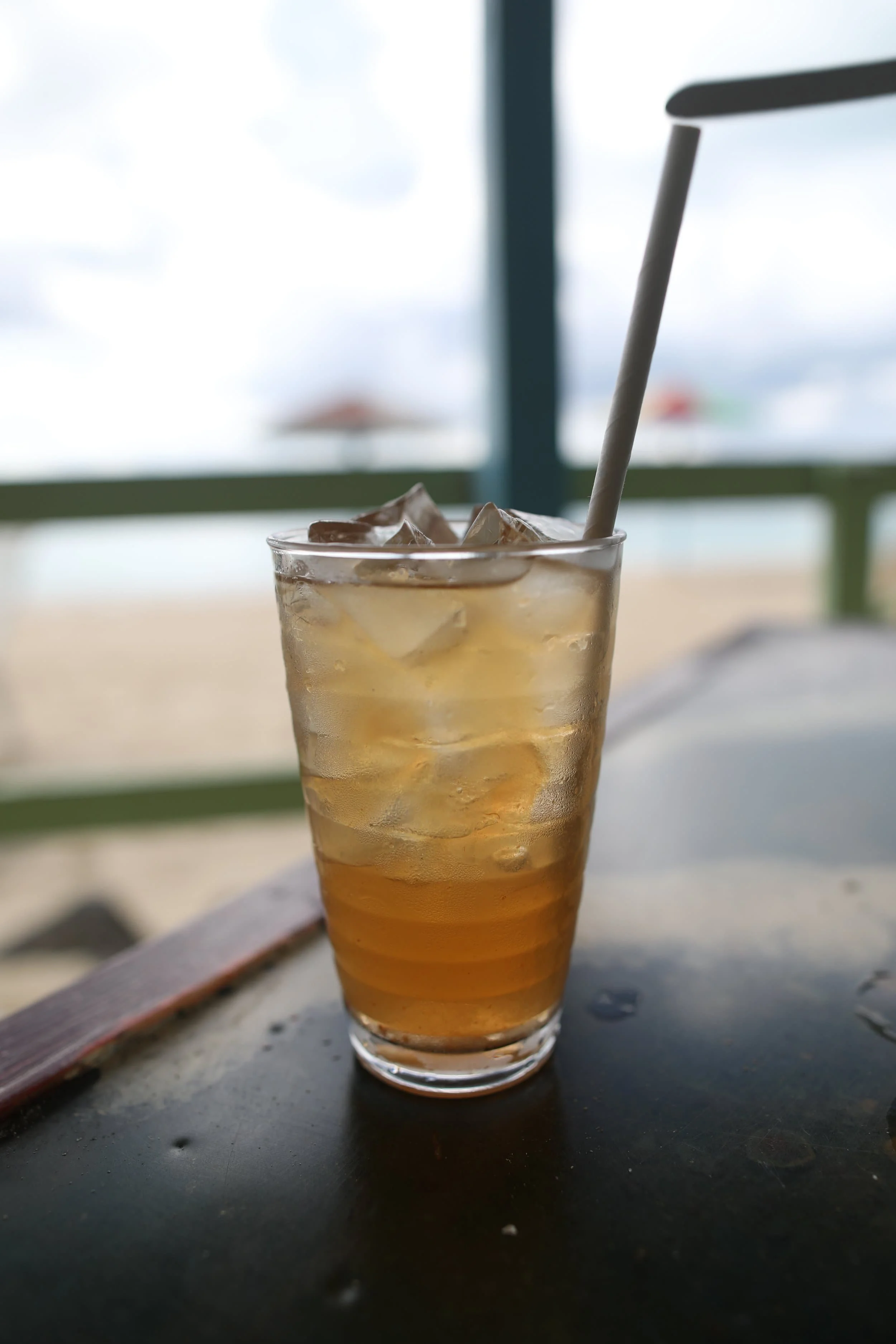  Tall fruit juice on table at Darkwood Beach on Antigua island 