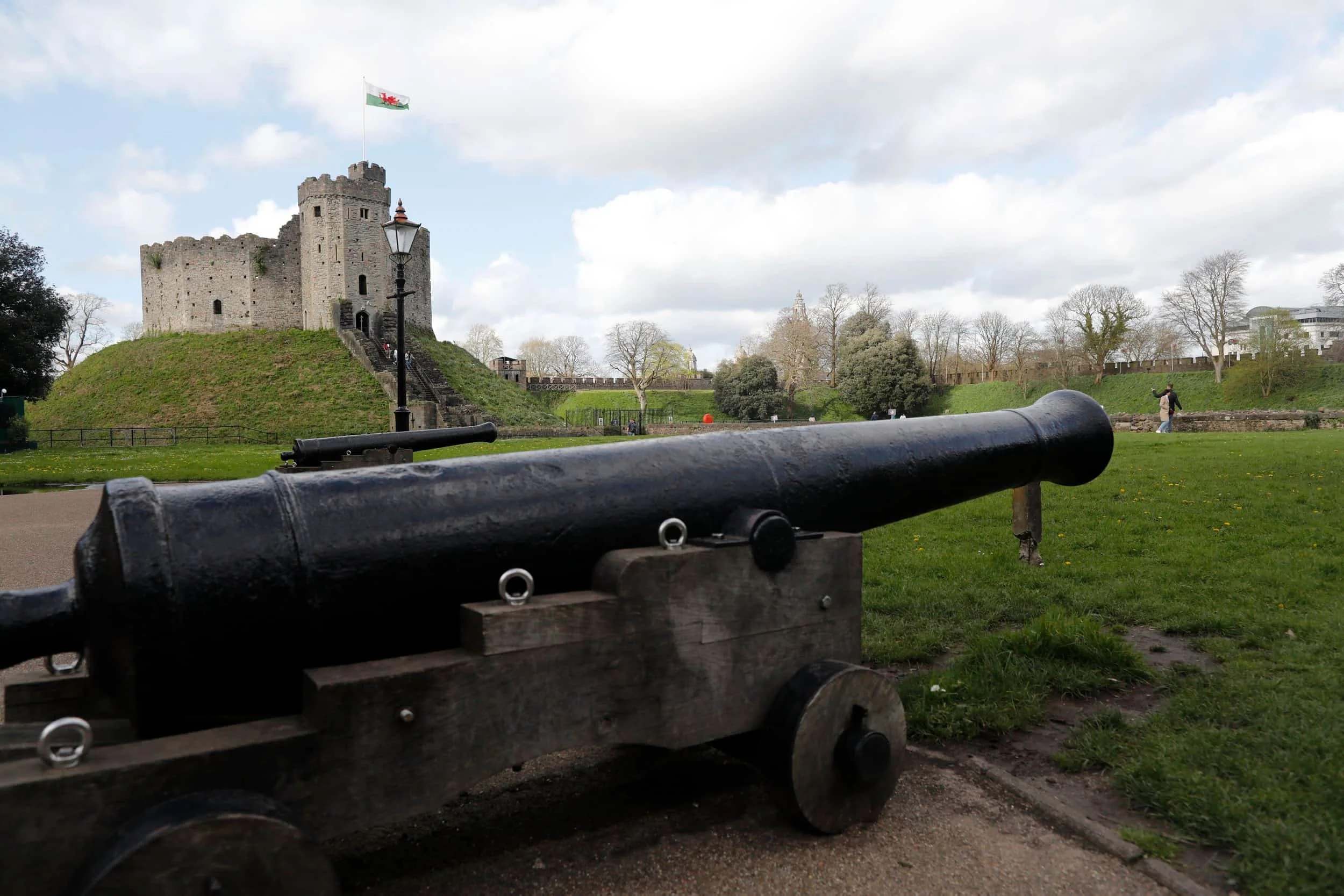  Cardiff Castle and canon with green lawn and blue sky, Cardiff UK 