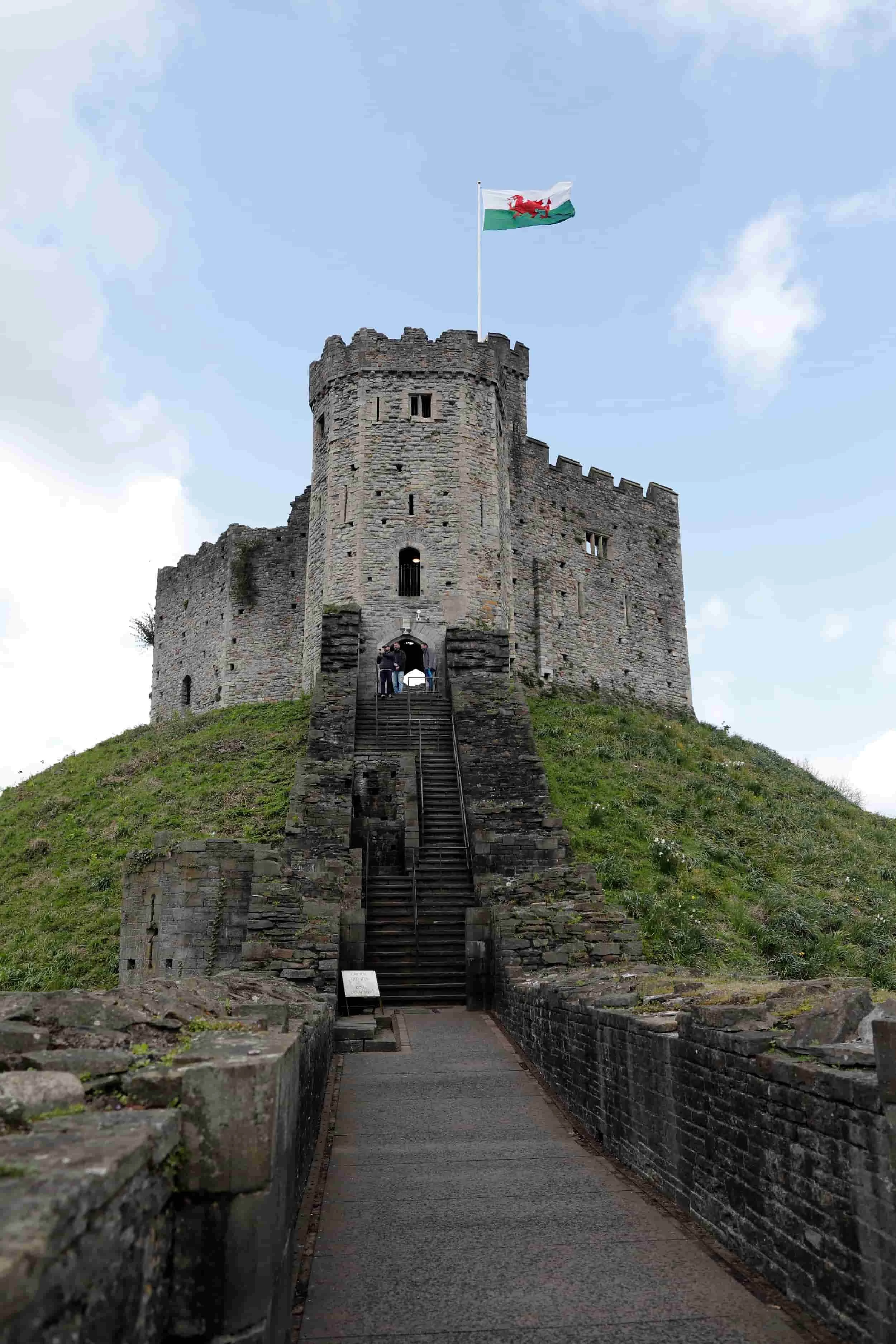 Stairs leading to Cardiff Castle on a green lawn with blue sky, Cardiff UK