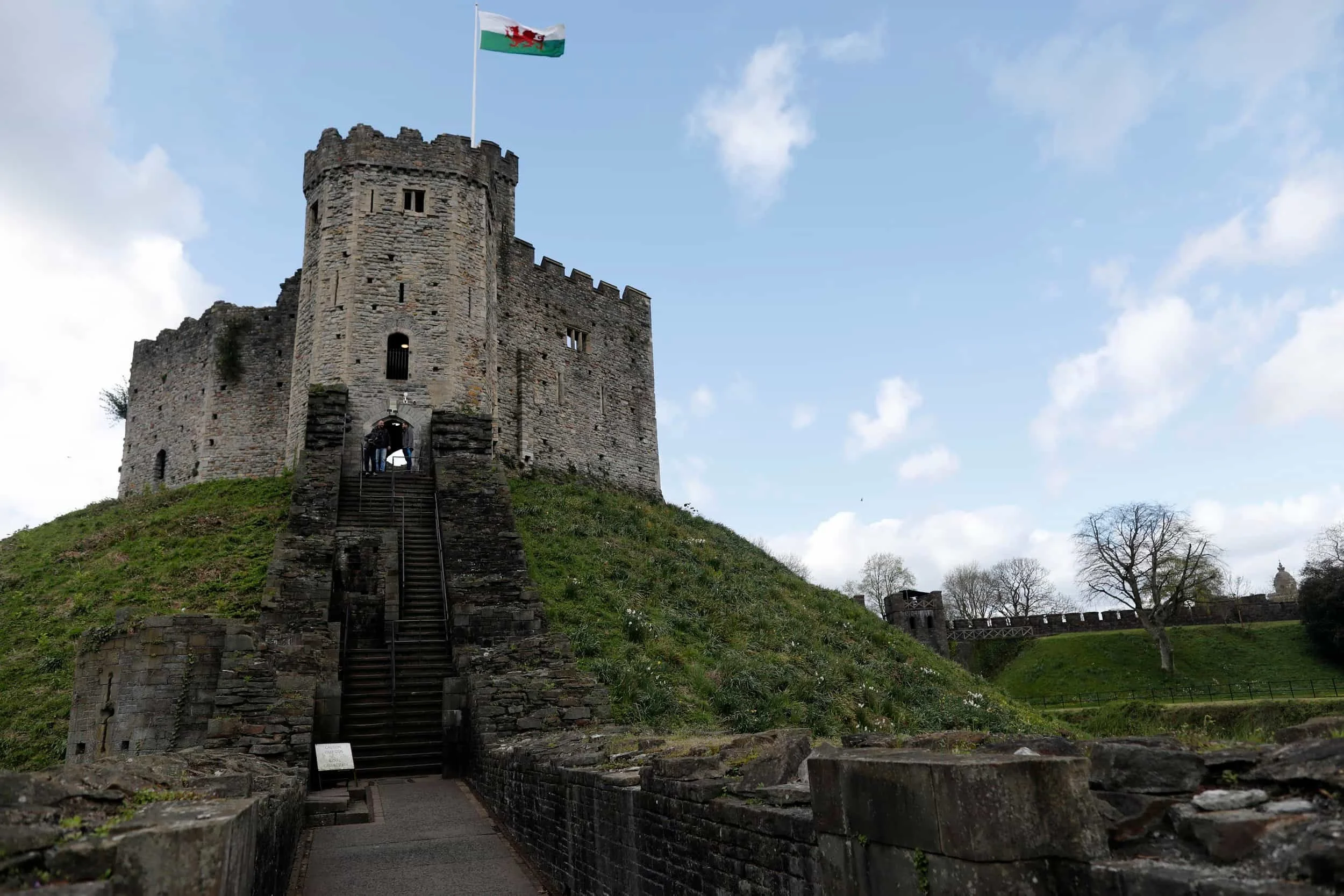Stairs leading to Cardiff Castle on a green lawn with blue sky, Cardiff UK