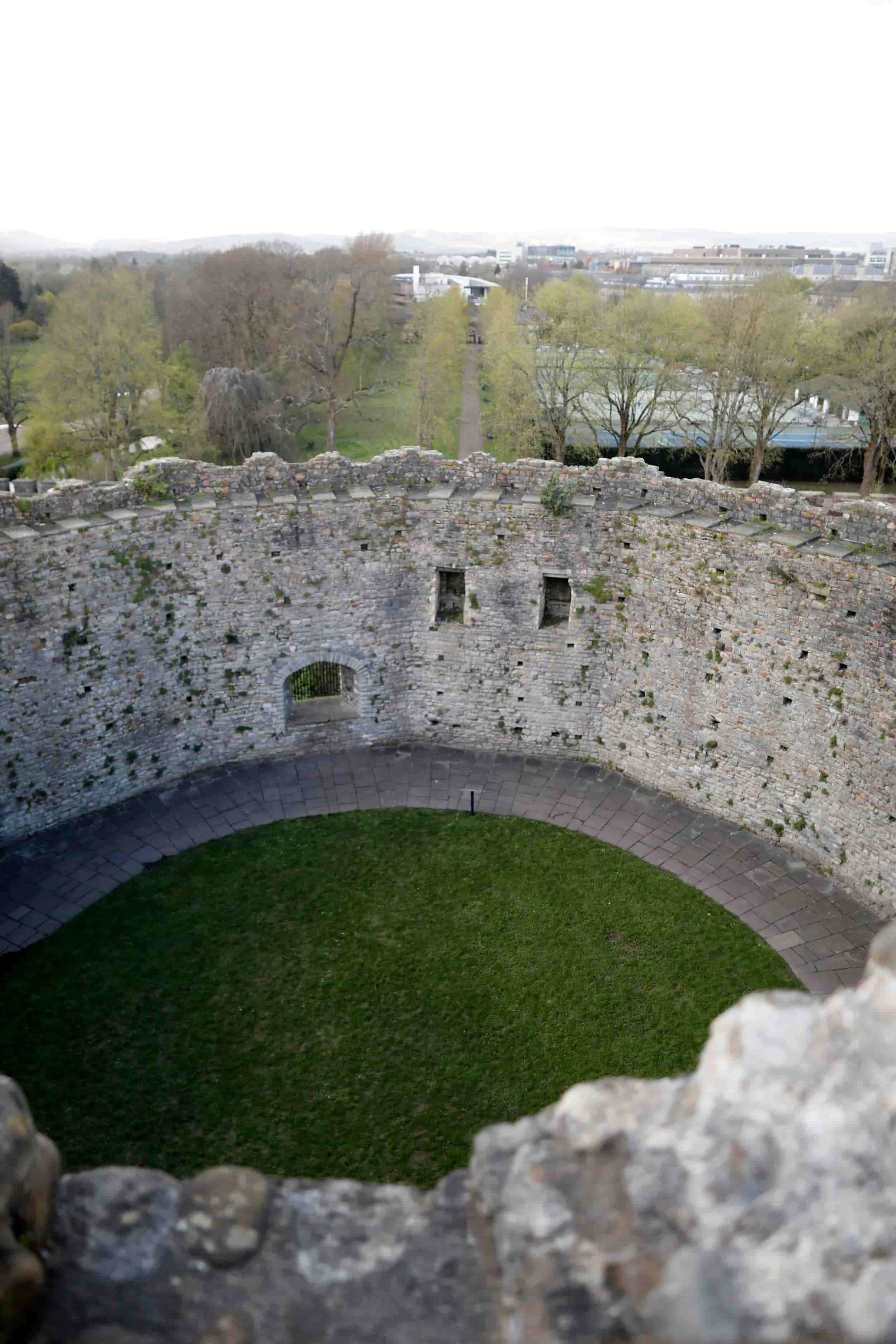 Views from atop Cardiff Castle to the interior stone walls and green grass, Cardiff Wales