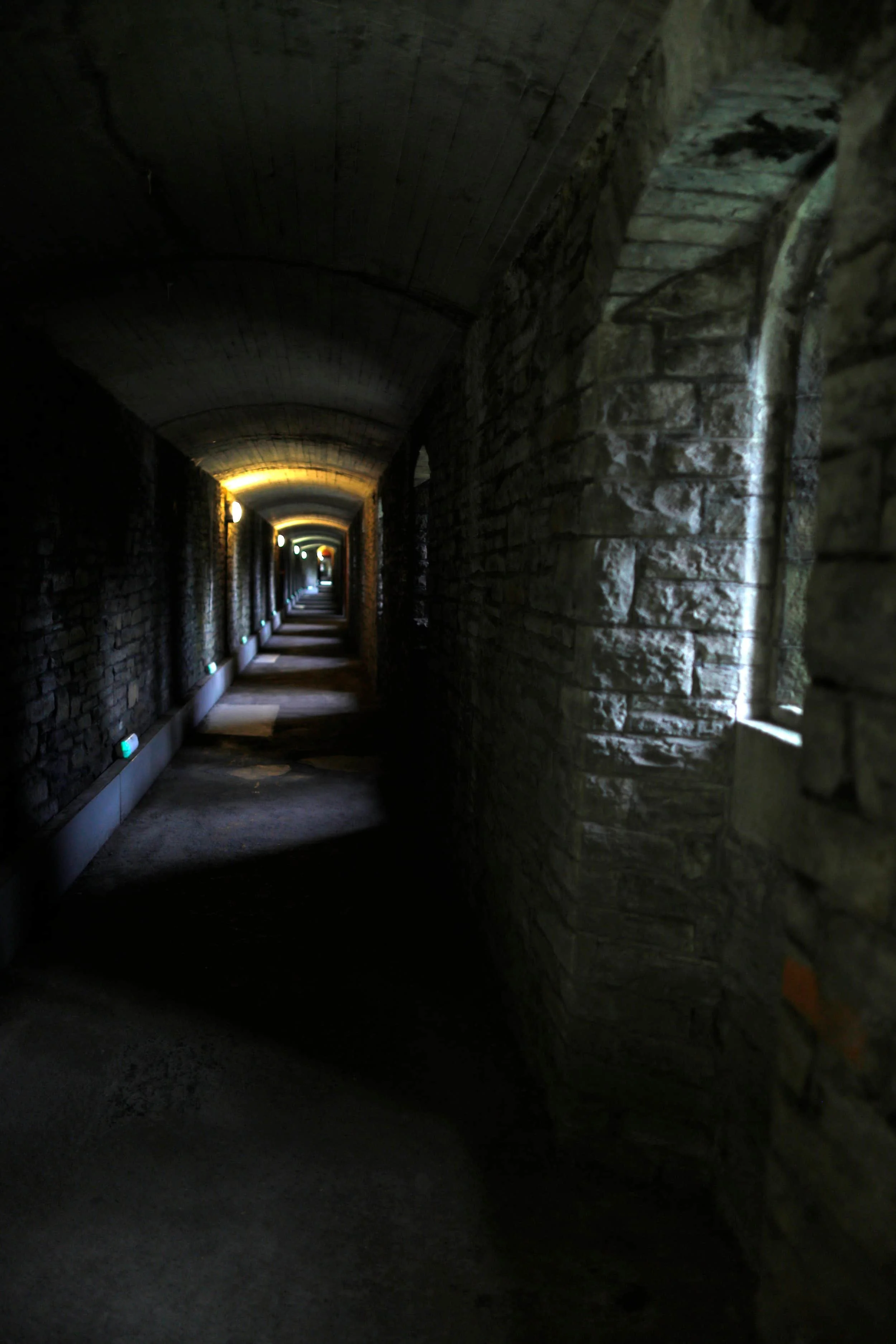 Wartime tunnels at Cardiff Castle, brick corridors with dim lights, Cardiff UK
