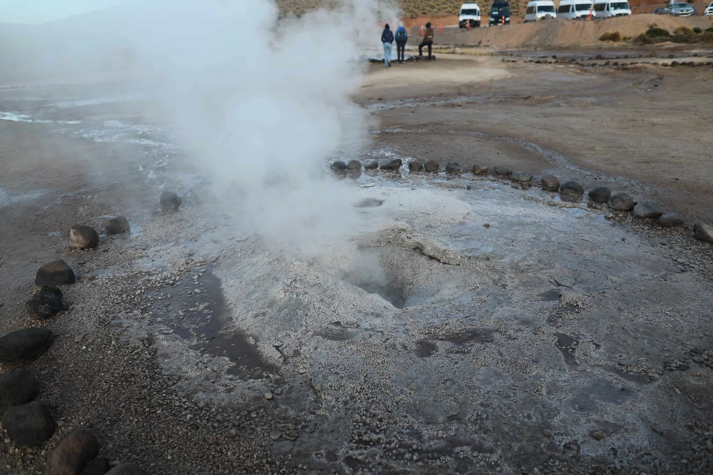 Bubbling geothermal pools and mineral-rich rock formations at El Tatio Geysers in the Atacama Desert.