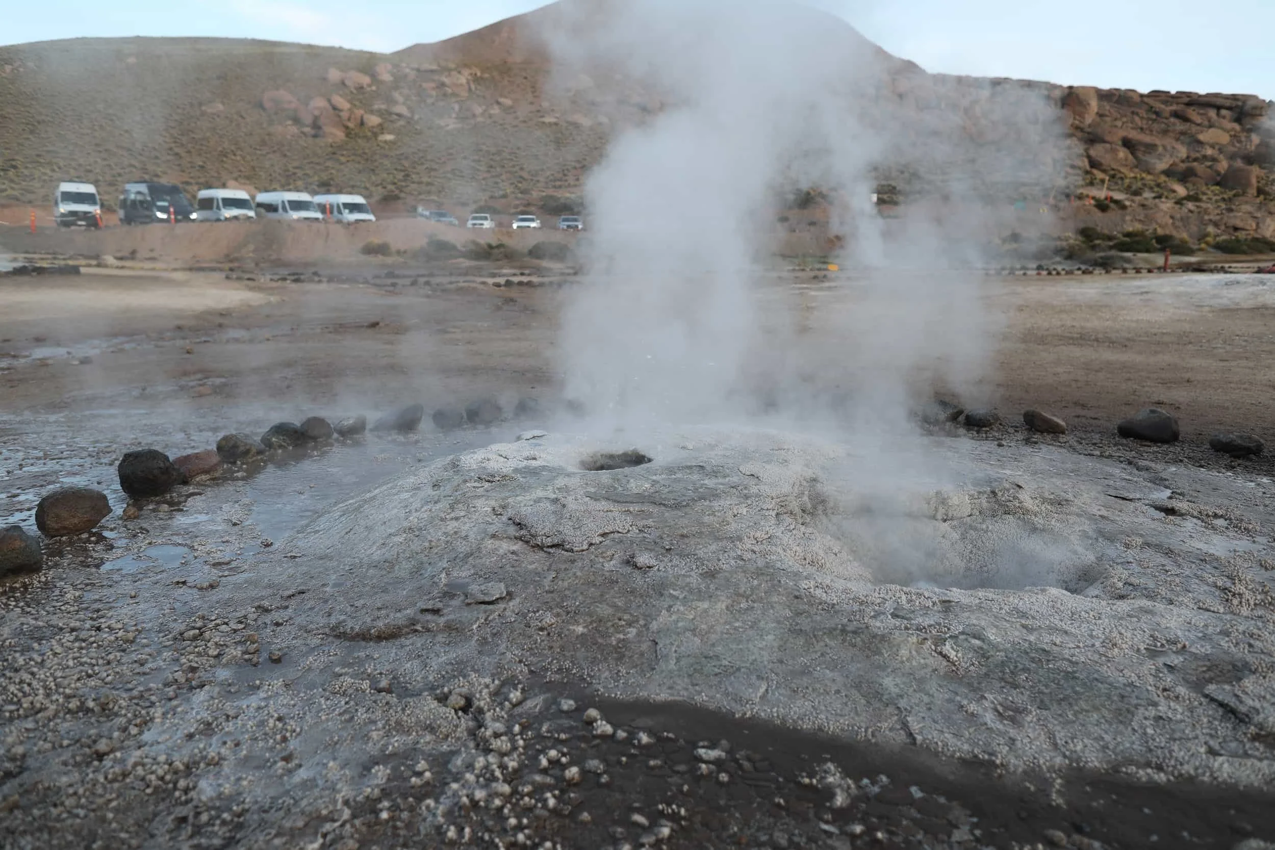 Bubbling geothermal pools and mineral-rich rock formations at El Tatio Geysers in the Atacama Desert.