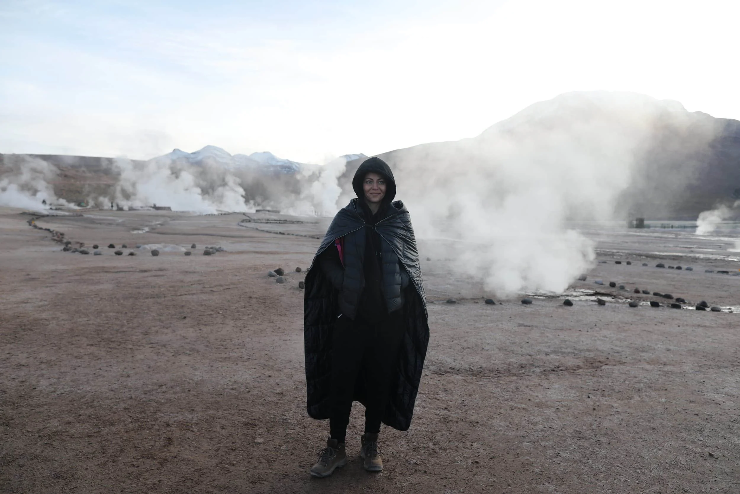  Steam rising from the El Tatio Geysers at sunrise, surrounded by the dramatic volcanic landscape of the Atacama Desert in northern Chile. 