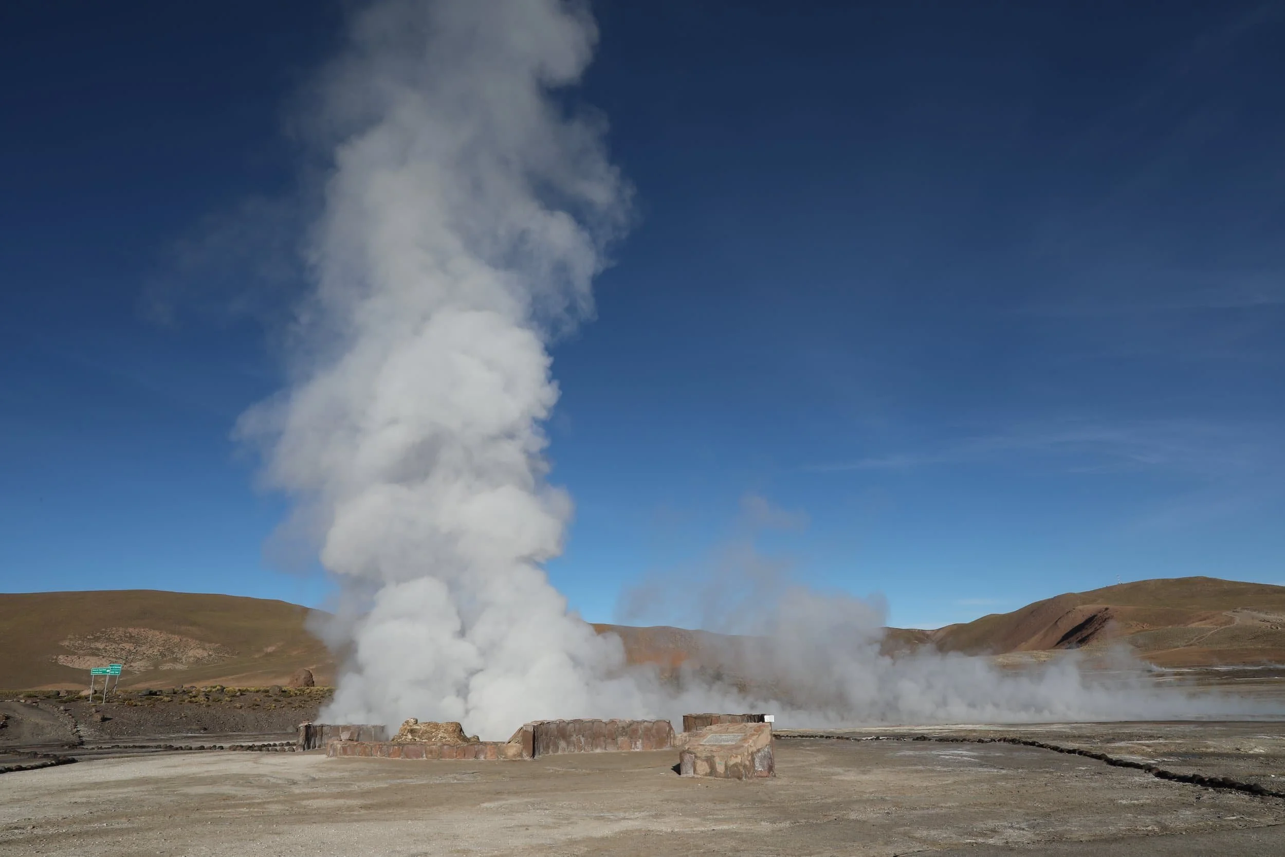 Panoramic view of El Tatio Geysers in Chile, with geothermal steam rising across the high-altitude Andes.