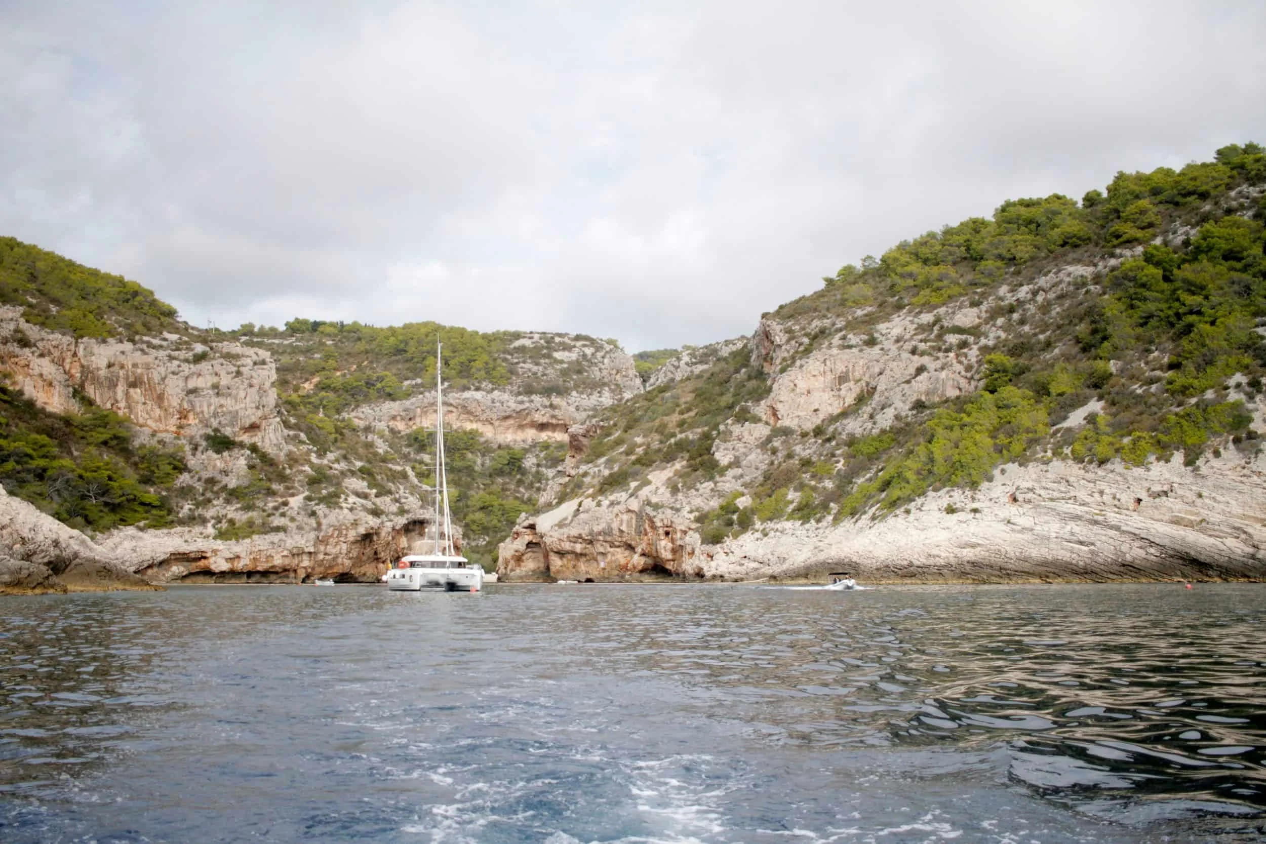 Sailboat in front of Stiniva Cove, a hidden beach on Vis Island