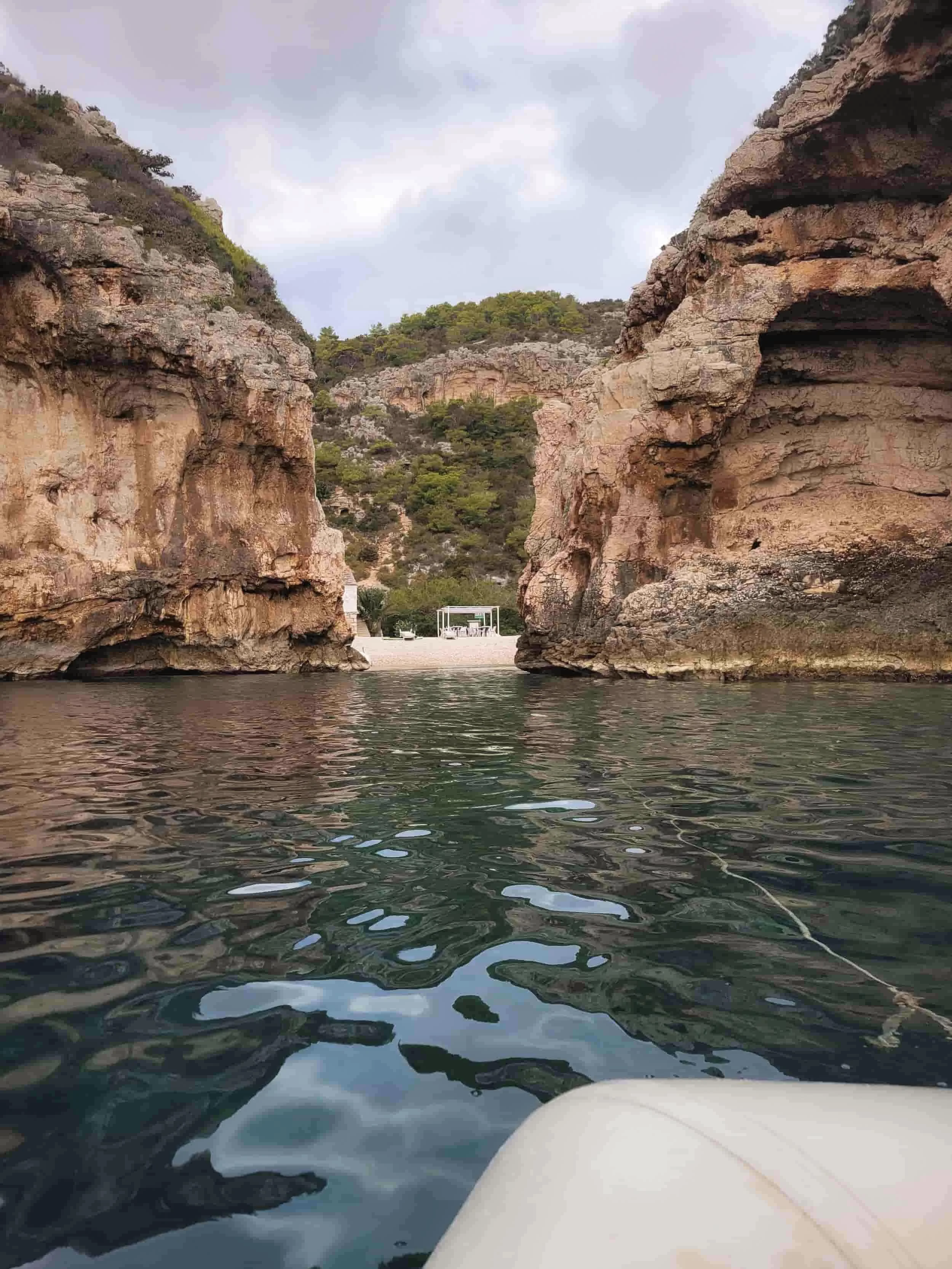Views to Stiniva Cove with cliffs surrounding a beach, Croatias Island of Vis