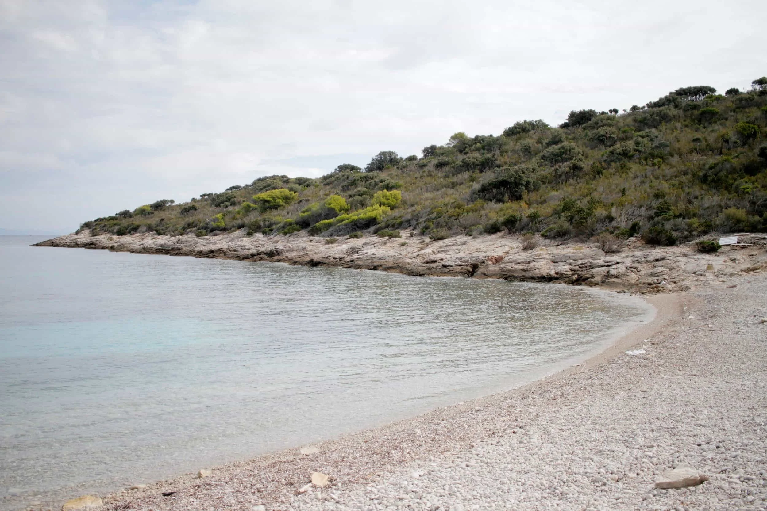 Blue Lagoon on Veliki Budikovac, Croatias islands, rocky coast and beach with green landscape