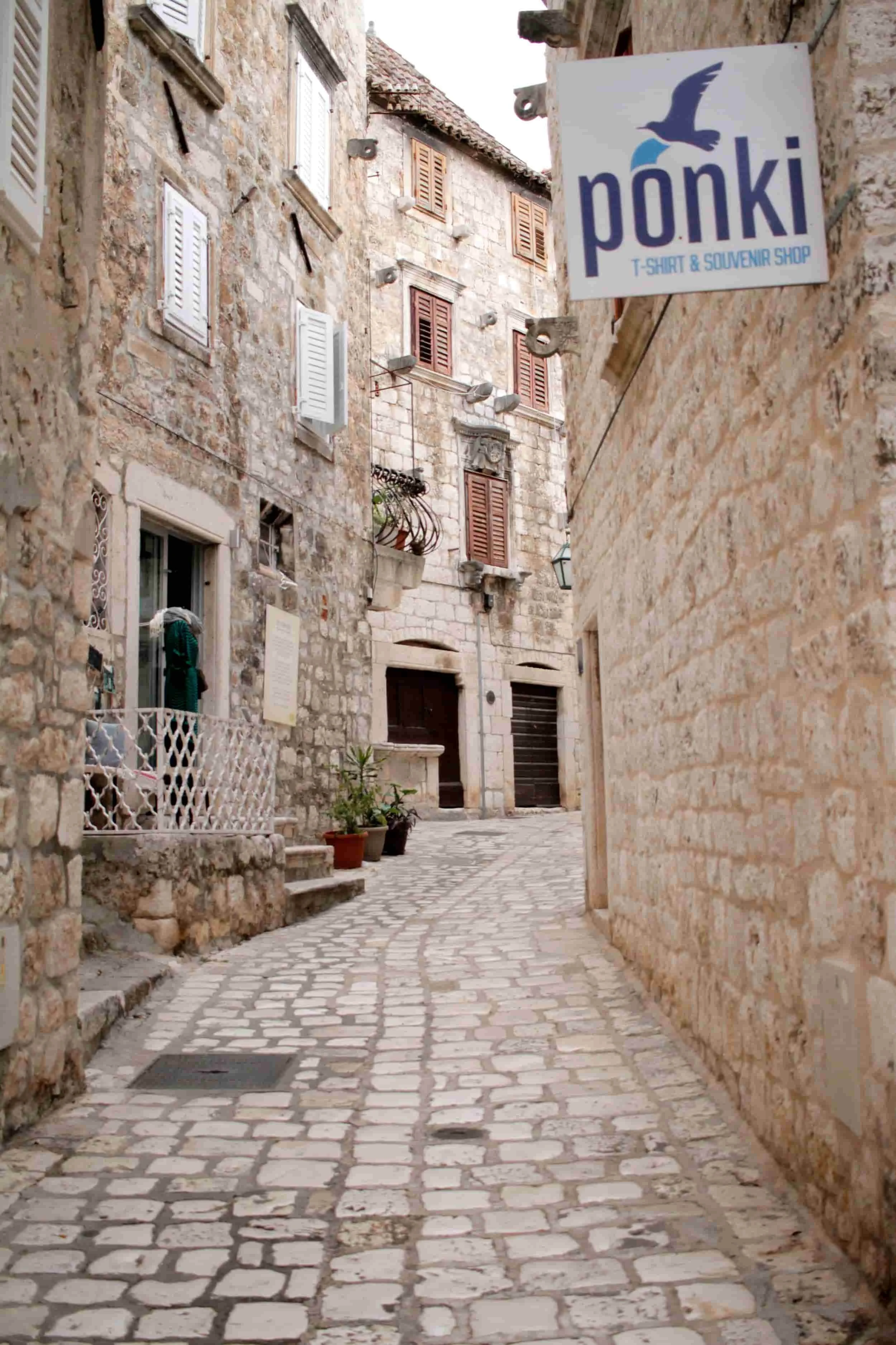 Alleyway with white stone path and buildings on Hvar Island on the Croatian coast