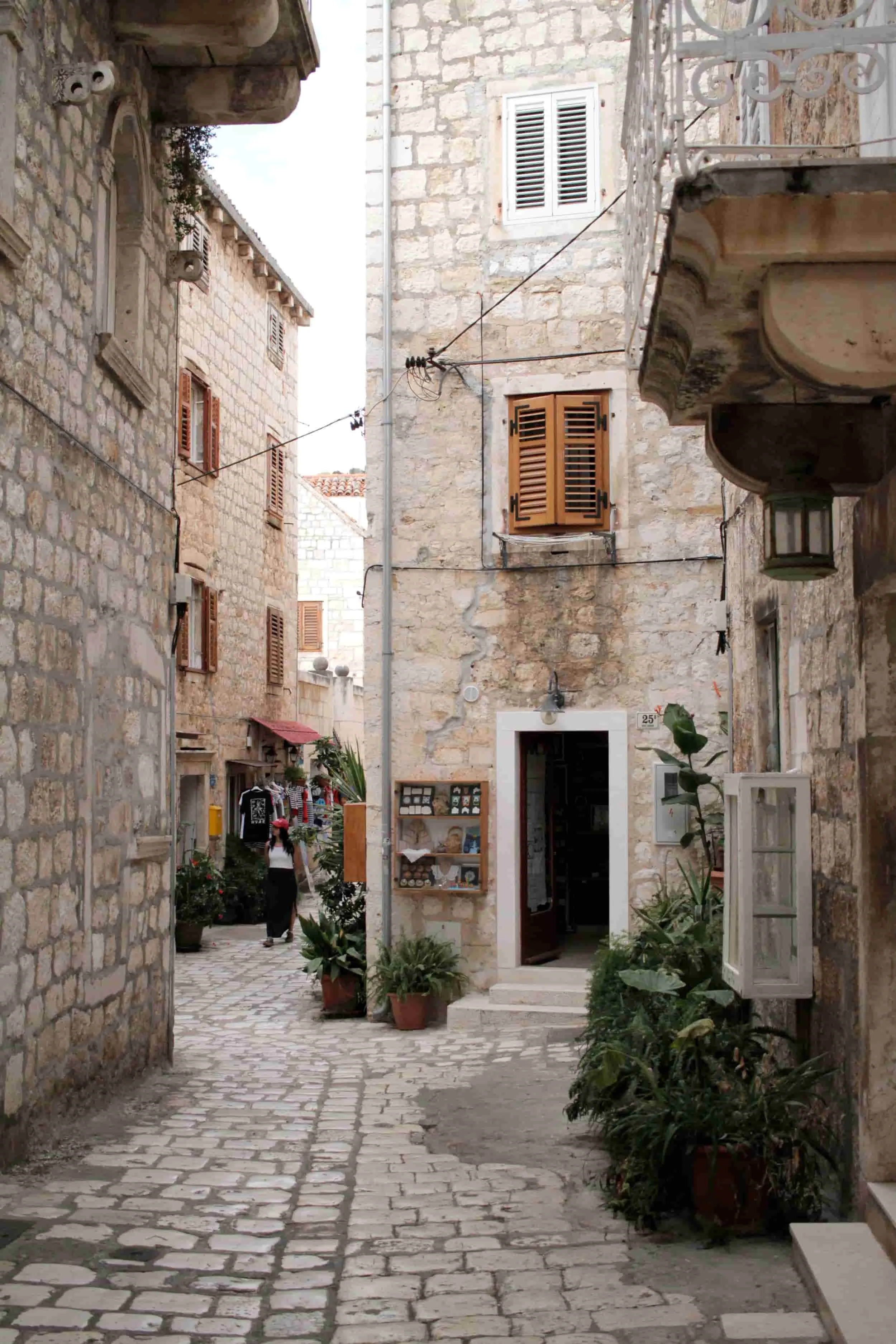 Alleyway with white stone path and buildings on Hvar Island on the Croatian coast