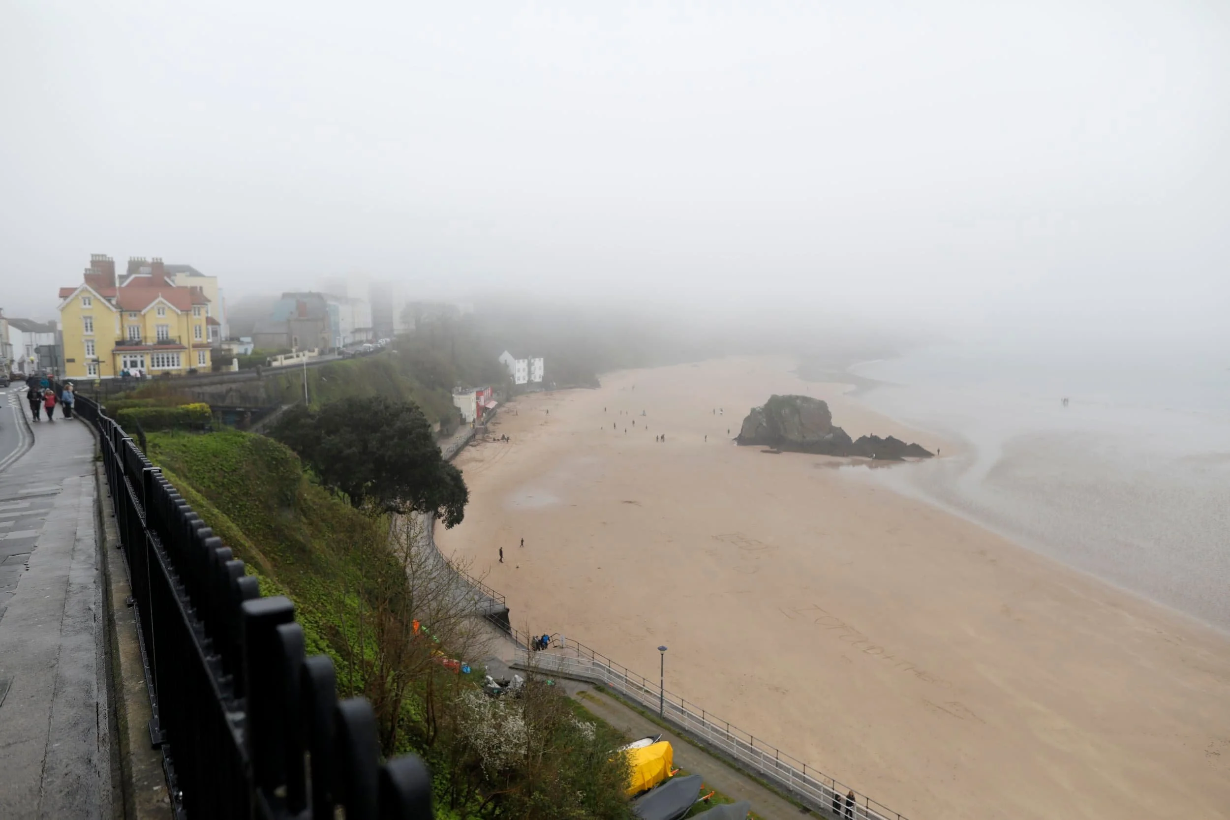 Views from above of the foggy beach and bay in Tenby Wales