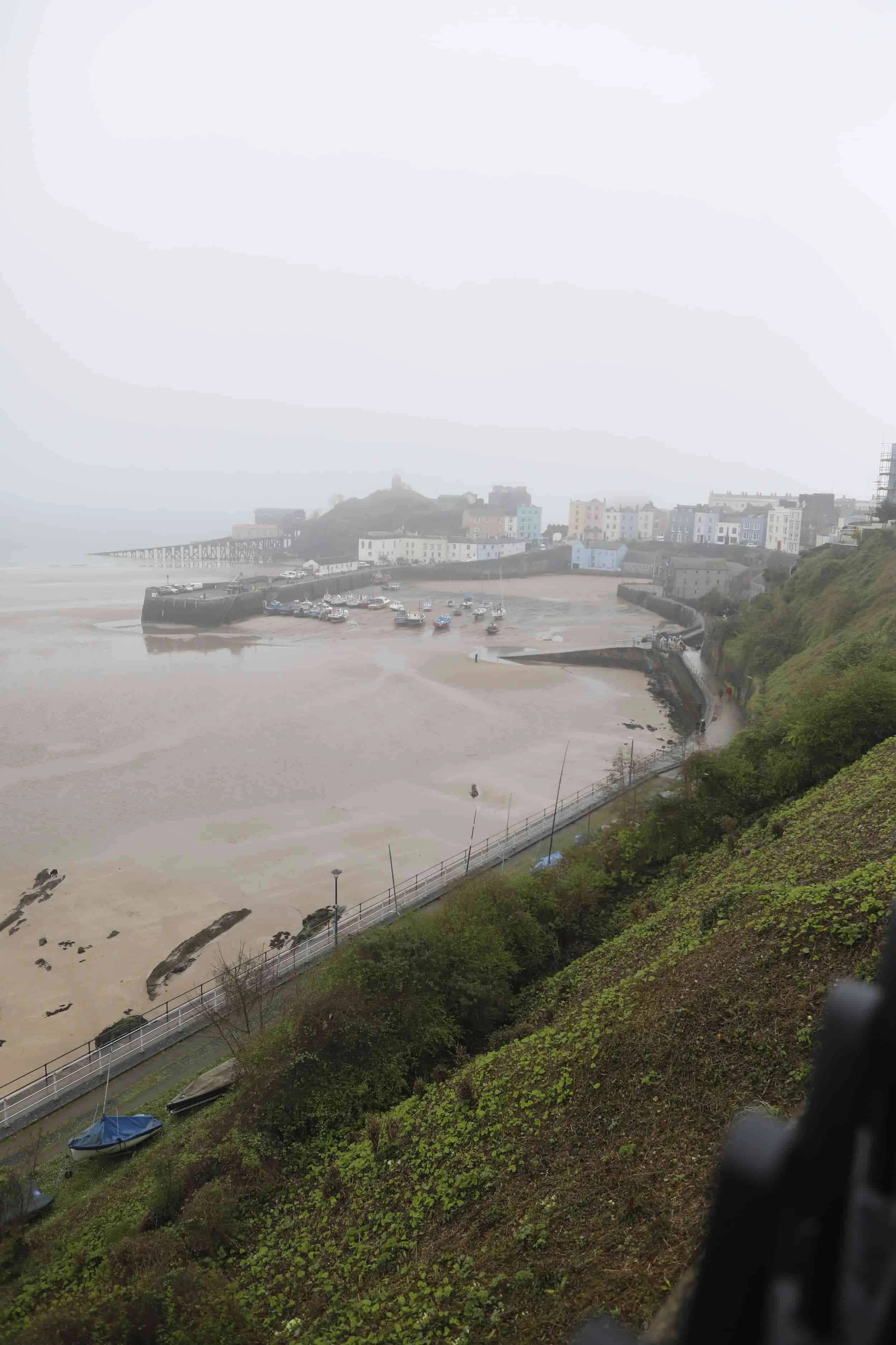 Views from above of the foggy beach and bay in Tenby Wales