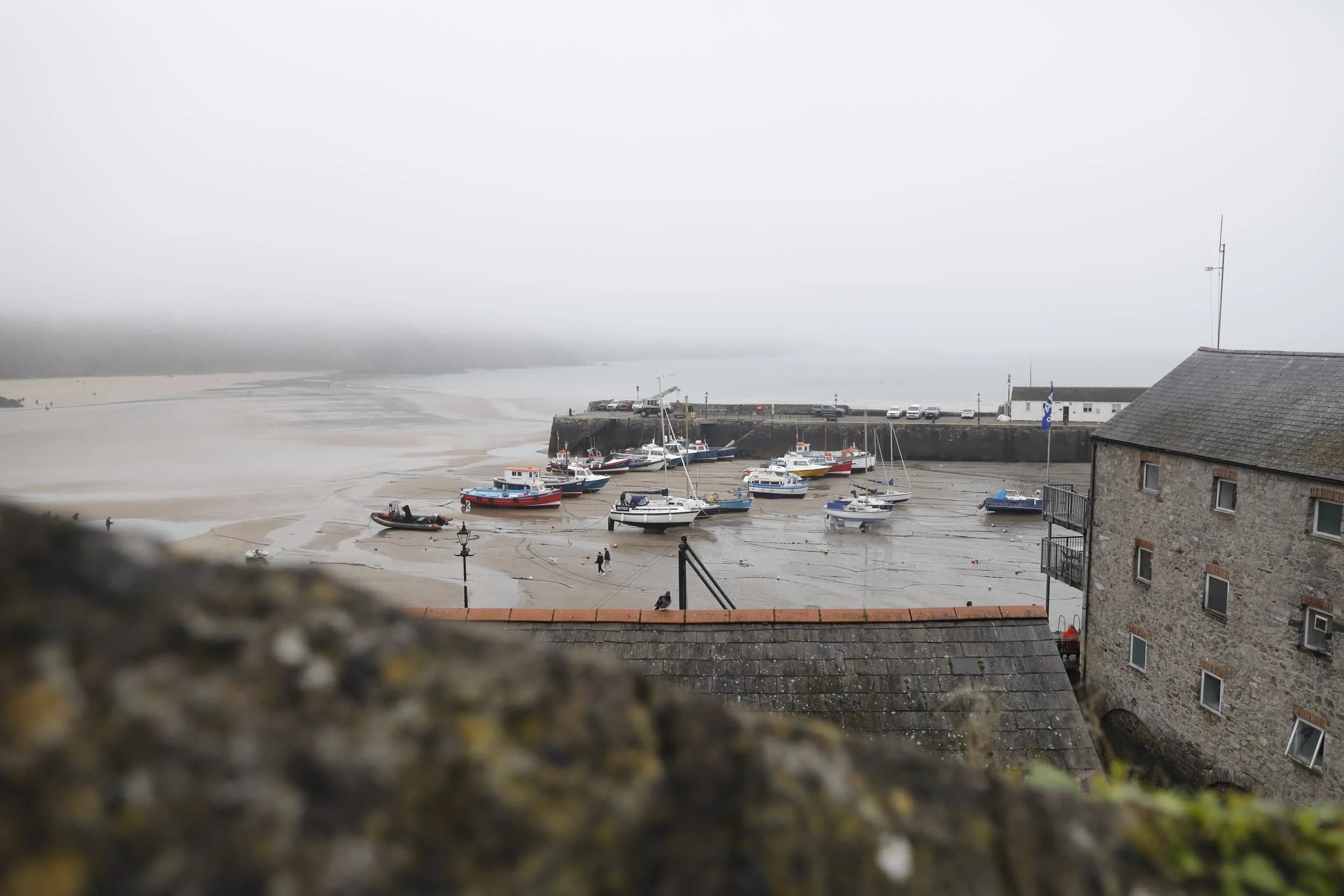 Views from above of the foggy beach and bay in Tenby Wales