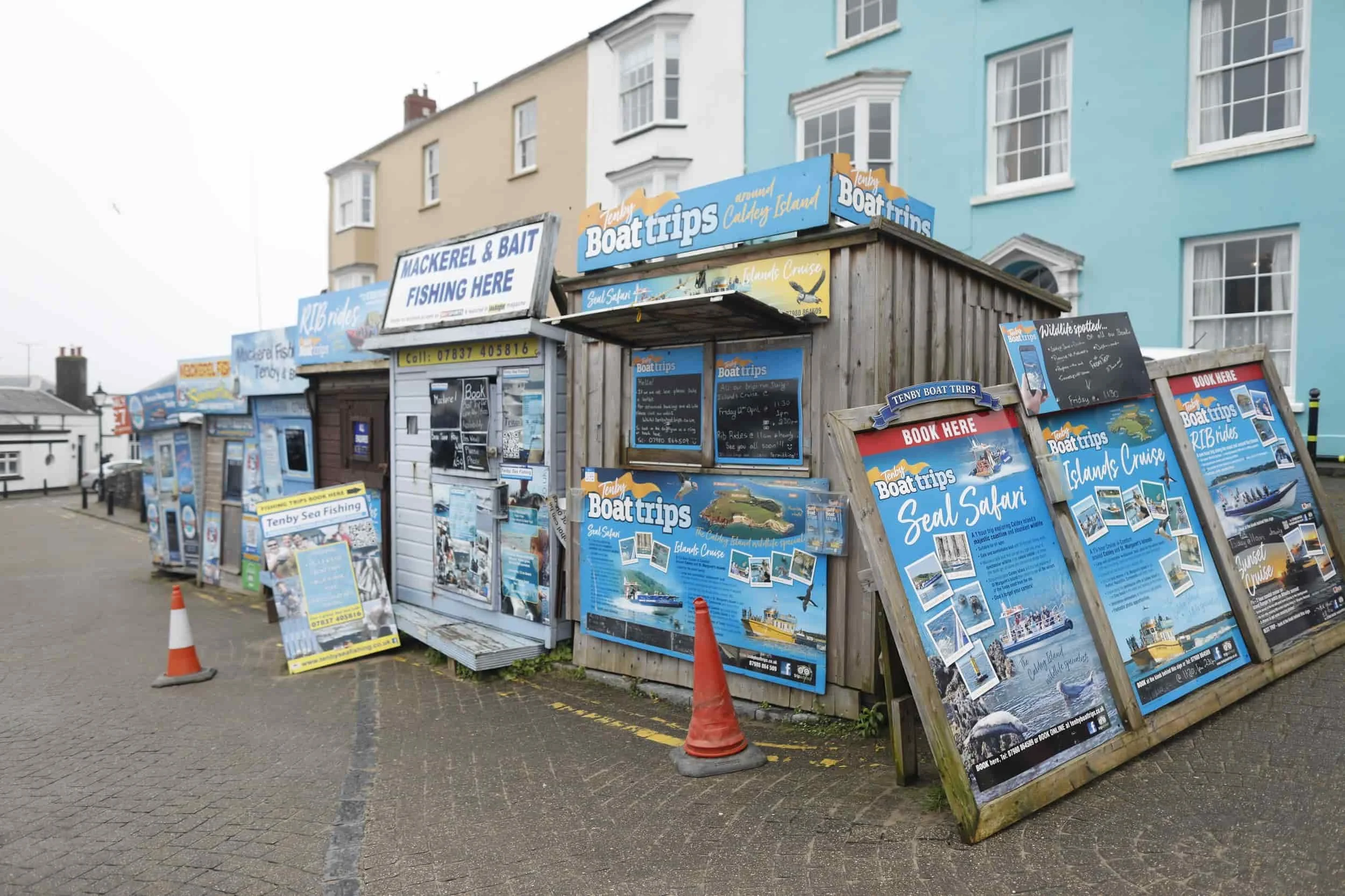 Boat trip and fishing stalls near the bay in Tenby Wales