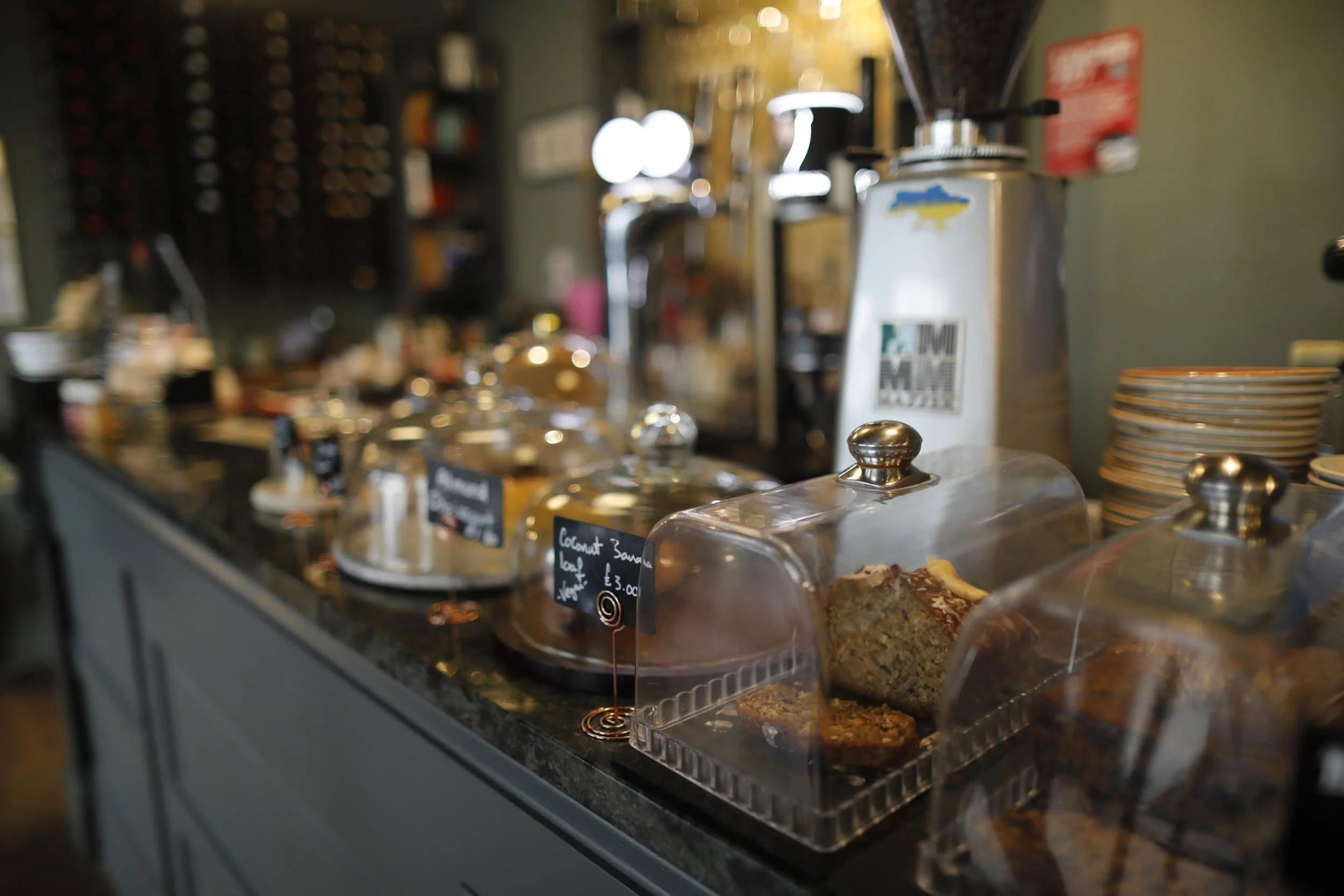 Interior of restaurant Fuchsia, with dishes filled with baked goods in Tenby Wales