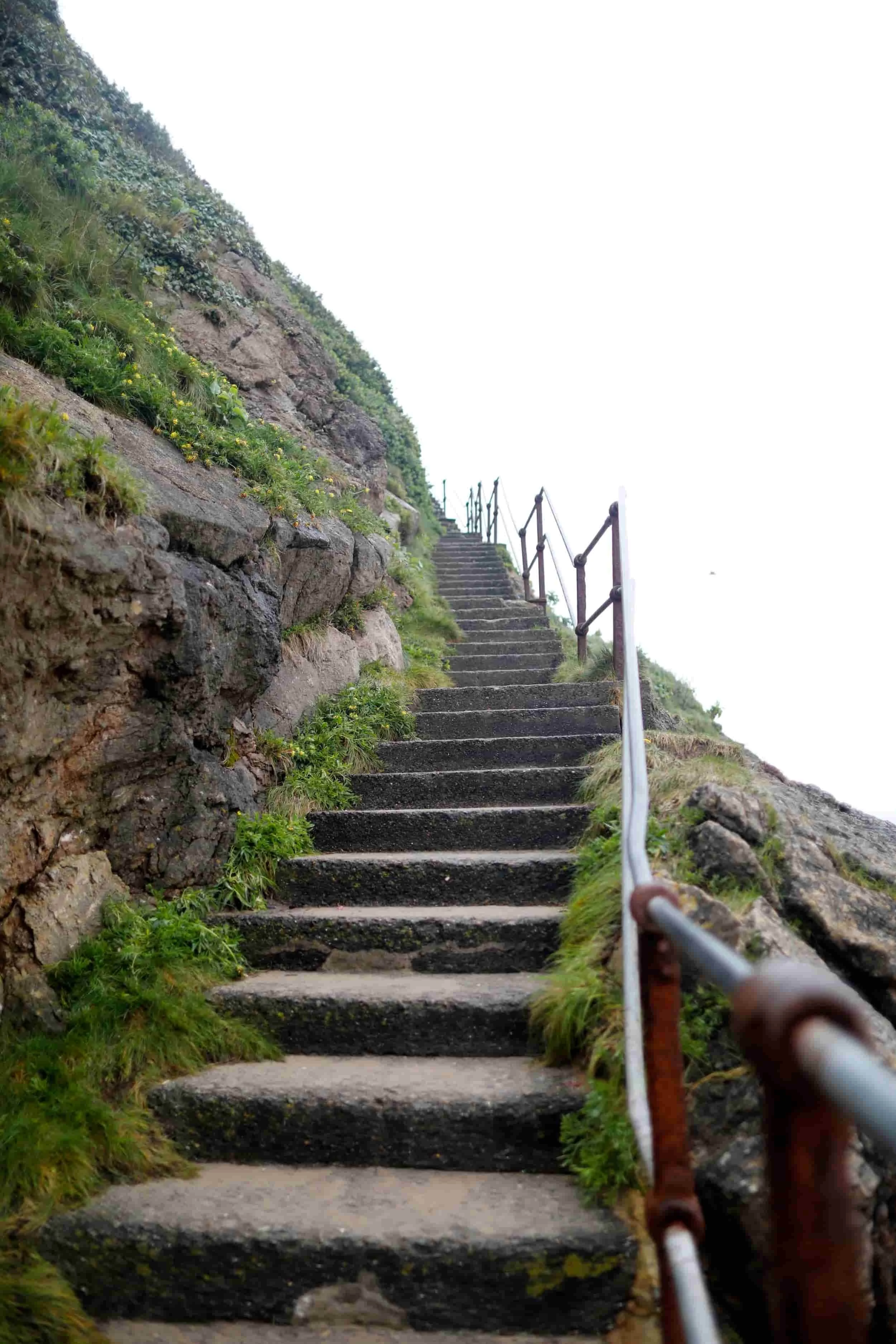 Steep set of stone steps on the side of a rocky outcrop in Tenby Wales